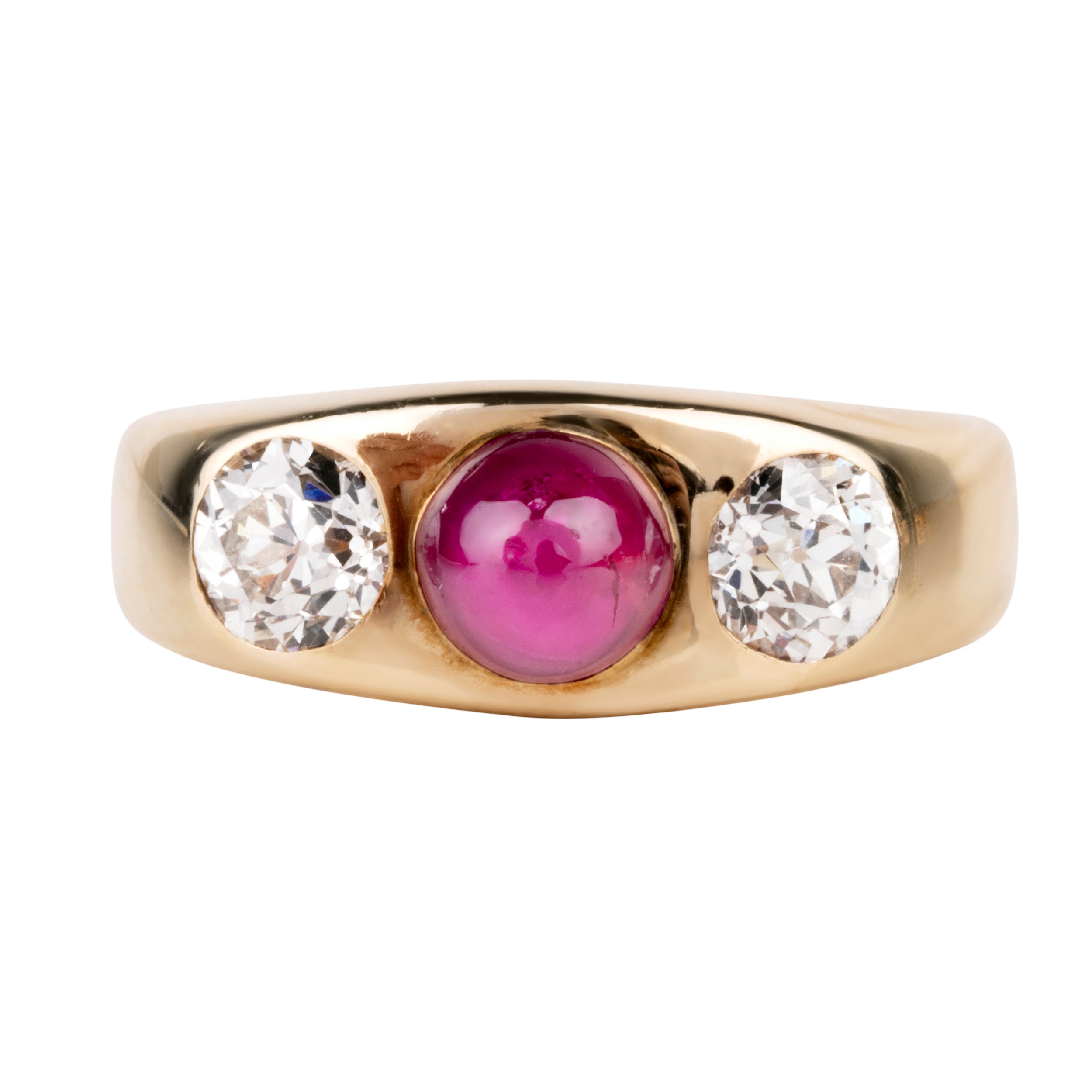 Early 20th century ruby and diamond three stone ring. In a flush 18k gold setting. Two old European cut diamonds flank a bright Burmese ruby cabochon with a high dome. English in origin. Circa 1910. Front view.