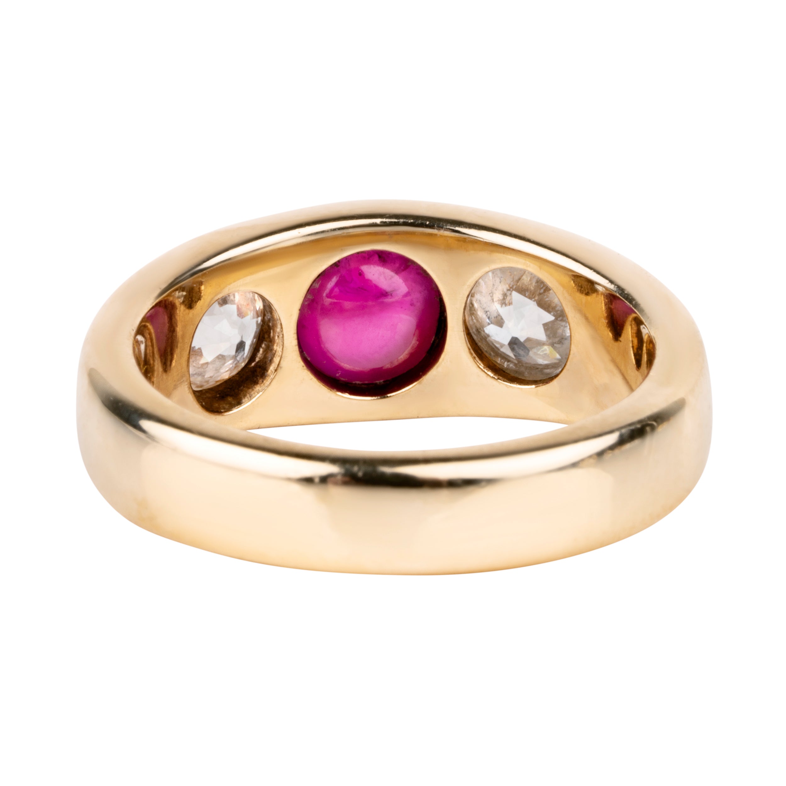 Early 20th century ruby and diamond three stone ring. In a flush 18k gold setting. Two old European cut diamonds flank a bright Burmese ruby cabochon with a high dome. English in origin. Circa 1910. Back view.