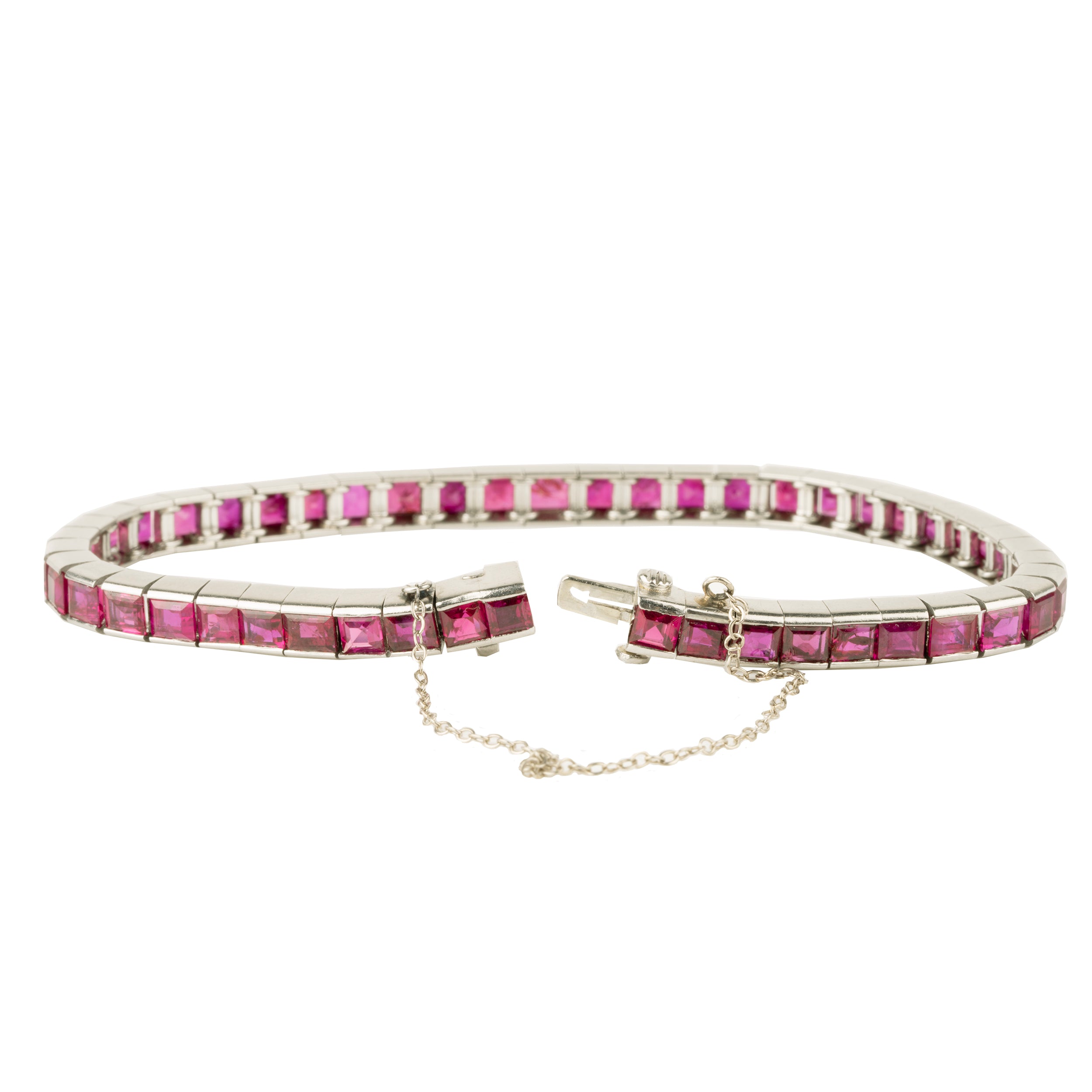 Art Deco ruby line bracelet. A fine early 20th-century platinum line bracelet. Natural deep red step-cut rubies are primarily Burmese in origin. Approximated at 11 carats in total stone weight. America, circa 1920. side view with the bracelet open showing the claps.
