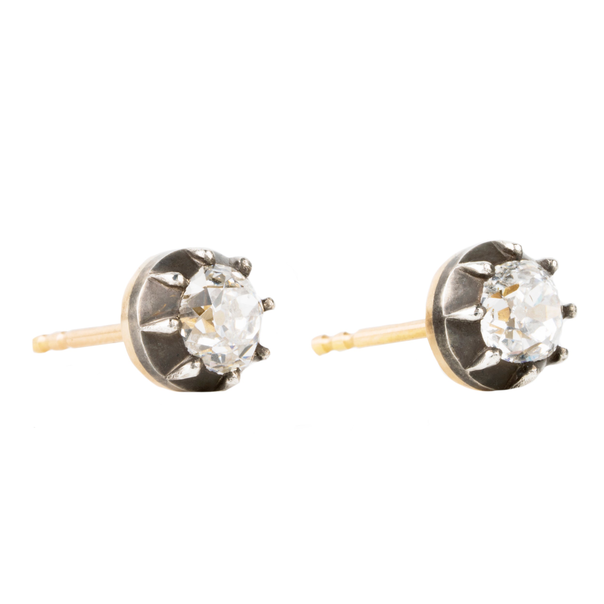 Our design for these earrings is inspired by Georgian and Victorian Era cutaway settings. Entirely hand fabricated they feature silver topped gold cutaway collet settings. This is a labor-intensive setting technique common in 18th and 19th century. These demure earrings feature two old mine cut diamonds, approximately 1.06 carats in total diamond weight , H-I color and SI1 / SI2 clarity. Hand engrave Bell & Bird markers mark. Side view.