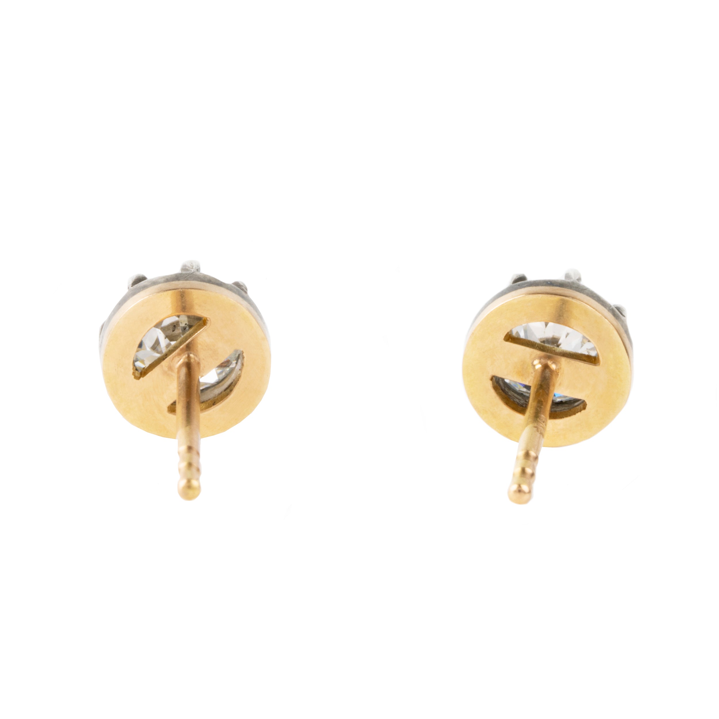 Our design for these earrings is inspired by Georgian and Victorian Era cutaway settings. Entirely hand fabricated they feature silver topped gold cutaway collet settings. This is a labor-intensive setting technique common in 18th and 19th century. These demure earrings feature two old mine cut diamonds, approximately 1.06 carats in total diamond weight , H-I color and SI1 / SI2 clarity. Hand engrave Bell & Bird markers mark. back view.