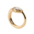 Bell and Bird No. 3931 ouroboros snake ring, one of our signature designs. The Ouroboros is a centuries-old symbol of eternity and wholeness. Completely hand fabricated in our custom color 18K old gold. Inspired by Victorian-era snake rings that have passed through our hands.
No castings or molds are used in production ensuring each snake is a unique one-of-a-kind piece. This example features a .84 carat pear-shaped old mine cut diamond. The diamond is GIA Certified, E color, VS2 clarity. Front view.