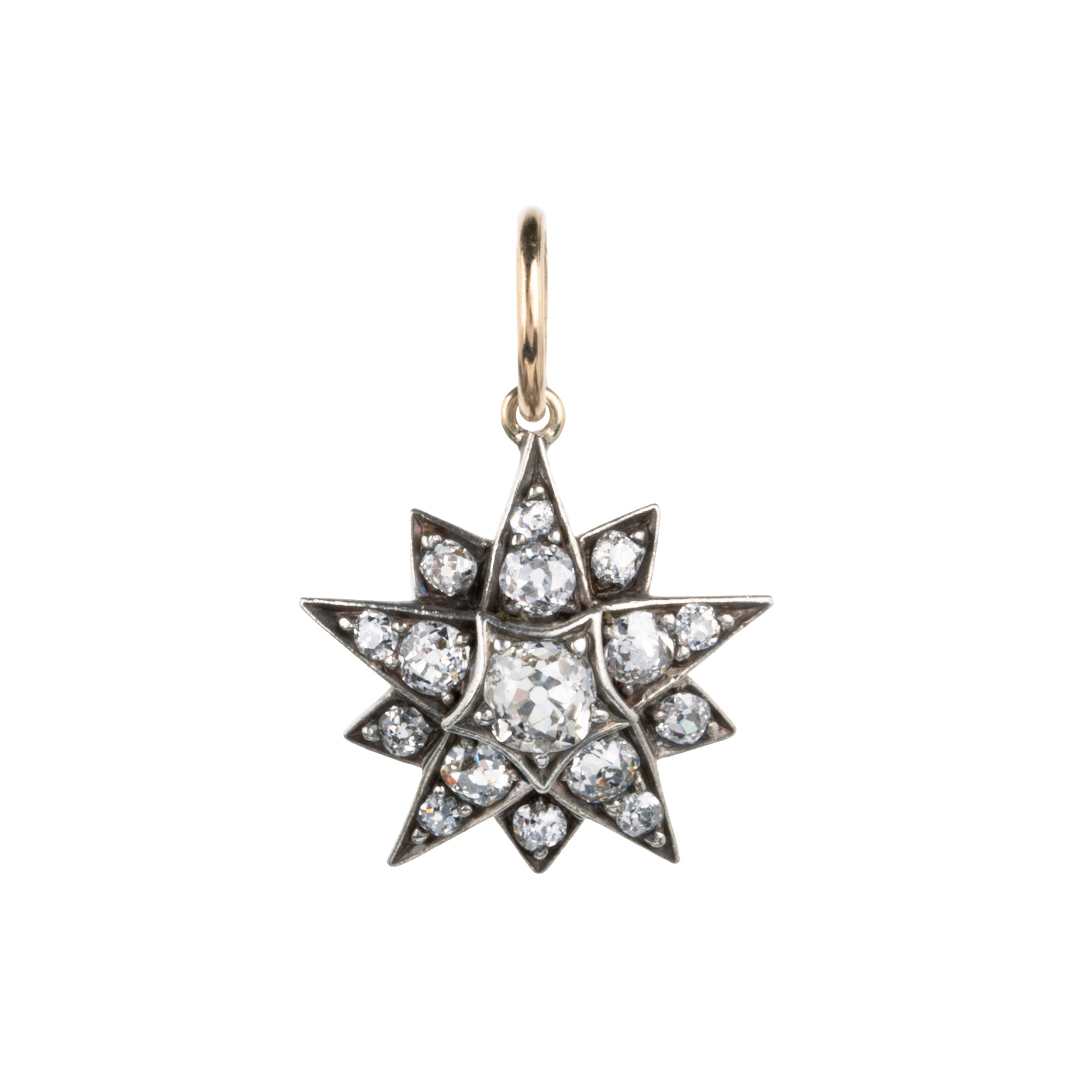 A lovely example of a 19th-century star pendant in silver-topped gold. It is a smaller scale than typically seen and very wearable. Sixteen bright old mine cut diamonds, with an estimated total diamond weight of two carats, English in origin. Circa 1880. Front view.