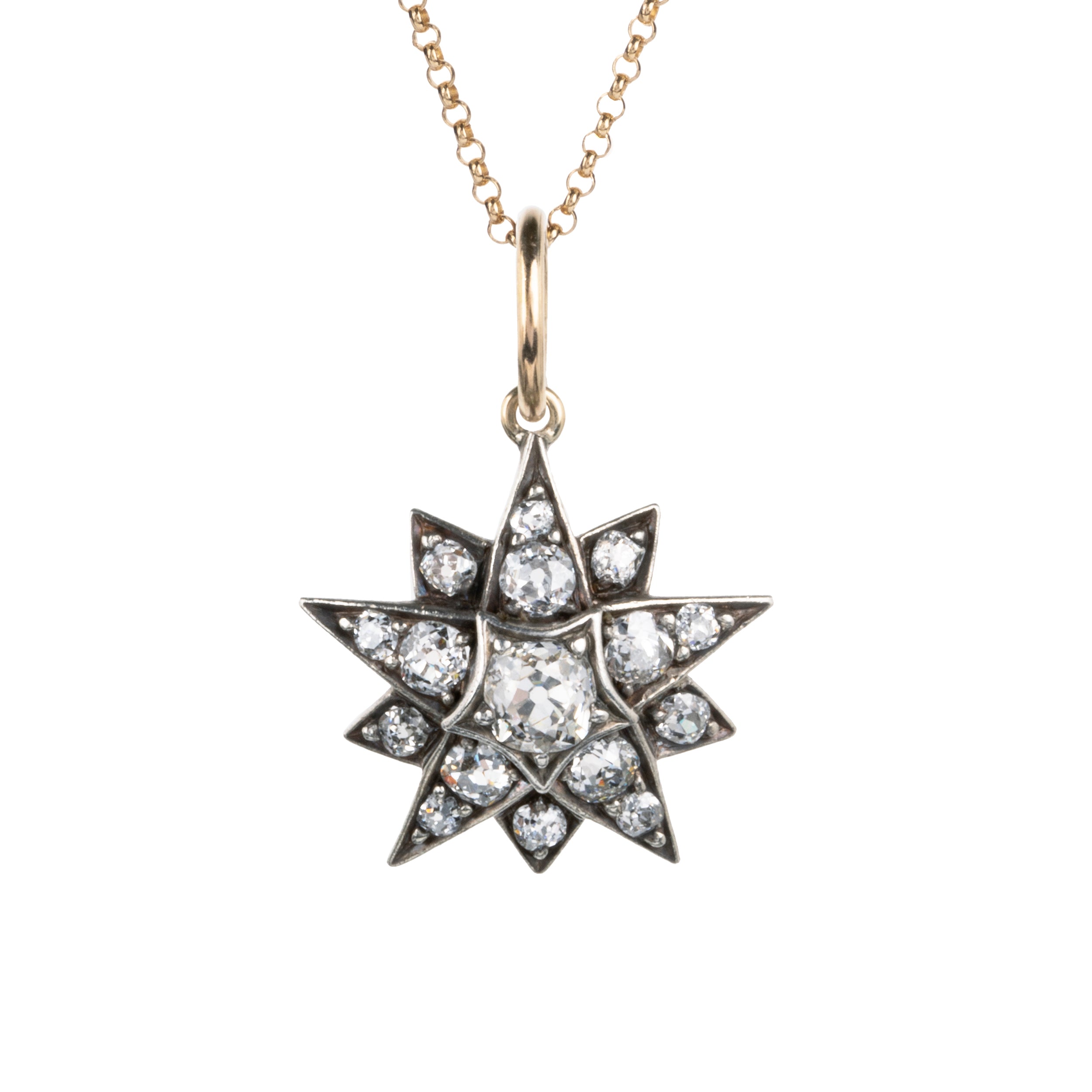 A lovely example of a 19th-century star pendant in silver-topped gold. It is a smaller scale than typically seen and very wearable. Sixteen bright old mine cut diamonds, with an estimated total diamond weight of two carats, English in origin. Circa 1880. Front view.