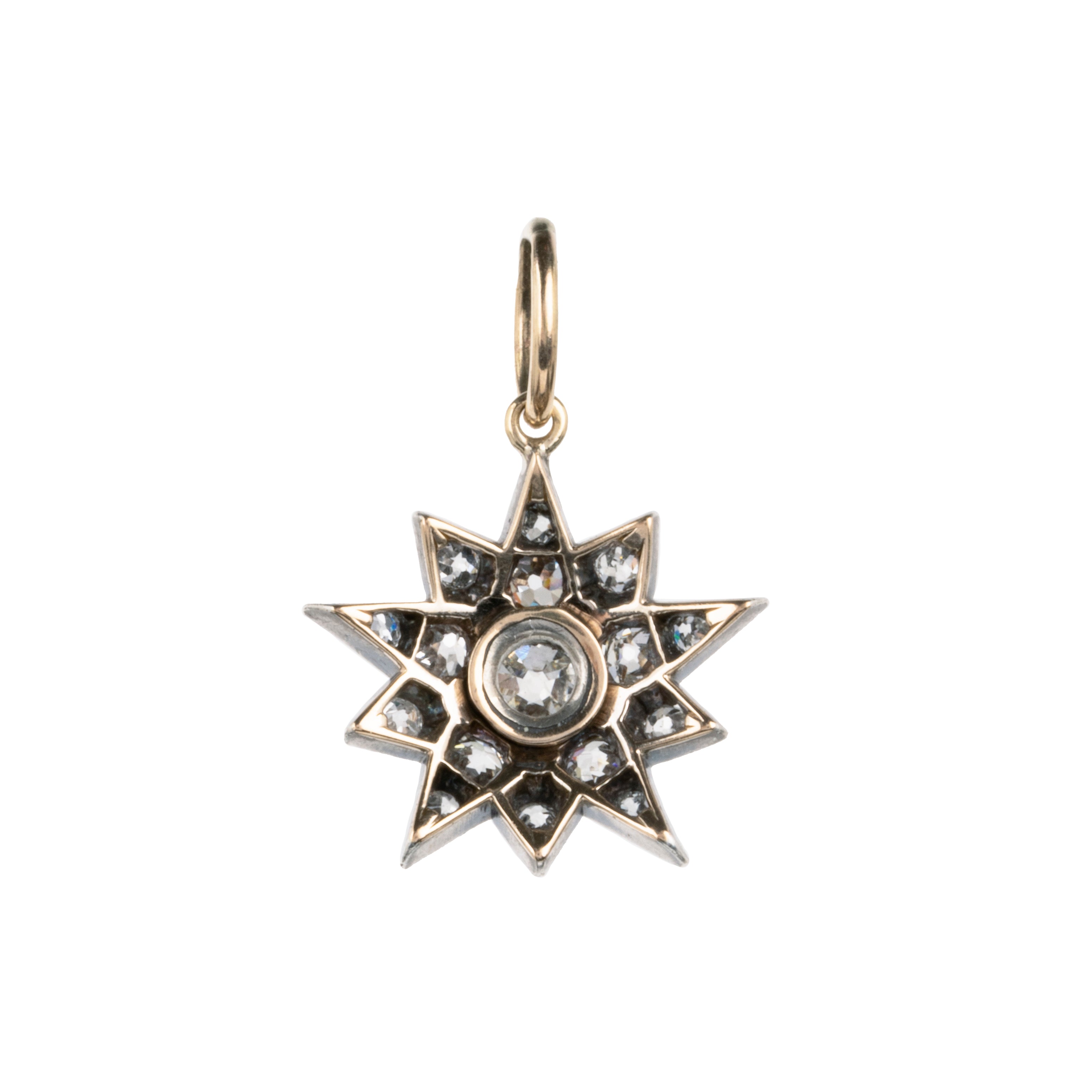 A lovely example of a 19th-century star pendant in silver-topped gold. It is a smaller scale than typically seen and very wearable. Sixteen bright old mine cut diamonds, with an estimated total diamond weight of two carats, English in origin. Circa 1880. Back side view.