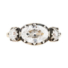 One of our signature designs, in silver-topped 18k gold. This design is inspired by a labor-intensive setting technique common in 18th and 19th-century rings. The silver-on-gold technique is true to the rings that inspired this design and is rarely seen in modern jewelry. This ring features a GIA certified cushion cut diamond, 1.58 carat, I color and VS2 clarity. The center stone is paired with approximately .30 carat and .28 carat I color and VS2 clarity old mine cut diamonds. Front view.