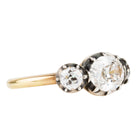 One of our signature designs, in silver-topped 18k gold. This design is inspired by a labor-intensive setting technique common in 18th and 19th-century rings. The silver-on-gold technique is true to the rings that inspired this design and is rarely seen in modern jewelry. This ring features a GIA certified cushion cut diamond, 1.58 carat, I color and VS2 clarity. The center stone is paired with approximately .30 carat and .28 carat I color and VS2 clarity old mine cut diamonds. Side view.