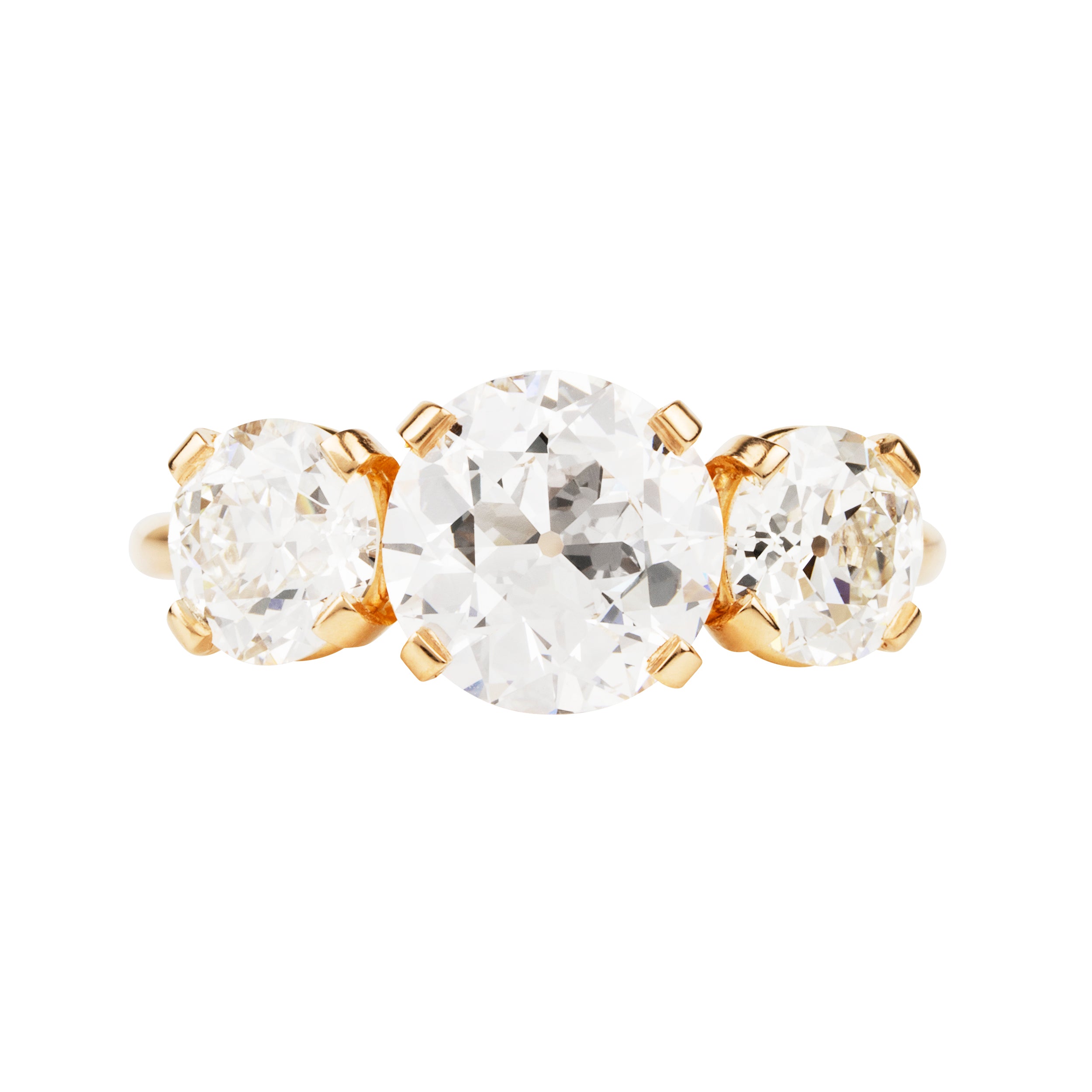 A classic three-stone diamond ring in our 18k old gold featuring a slim band. The center stone is set with four tab prongs. This example features three old European cut diamonds. The center stone in this example is 1.93-carat diamond, GIA-certified H color, and VS1 clarity. Flanked by 2 old European cut diamond side stones, 0.85 carats and 0.76 carats J Color/ VS1 clarity.