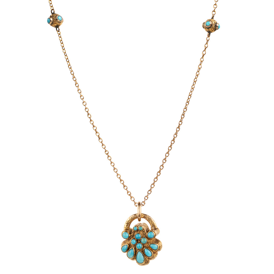 Early Victorian era turquoise padlock locket in 15k gold. It is in the form of a shell with Persian turquoise and a glazed compartment. English in origin. Circa 1840. Hanging on an antique 15k gold turquoise beaded ball chain.