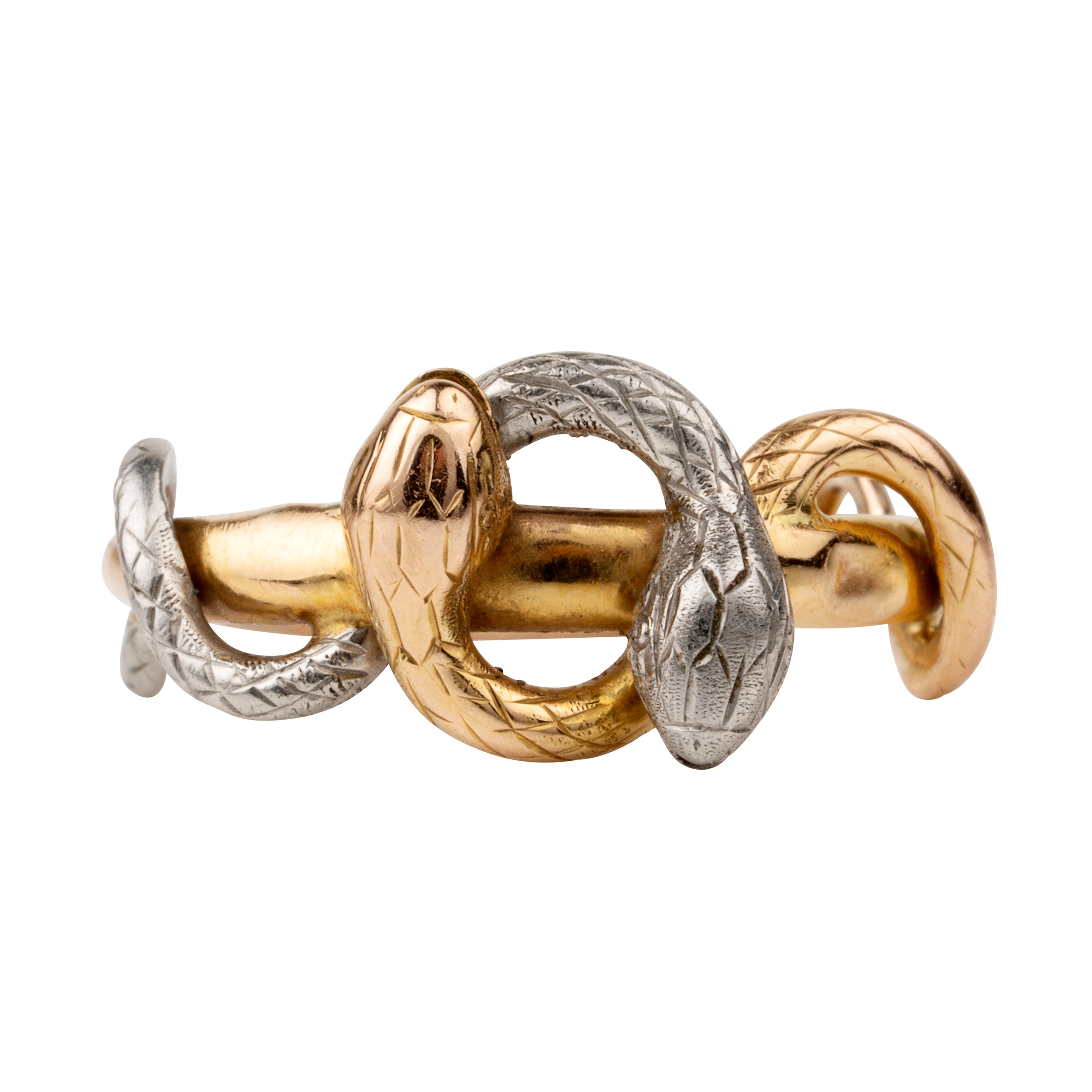 Turn of the century entwined snake ring, in platinum and gold. Hollow construction. There is a small dent on the band next to the platinum snake head. England. Circa 1910.