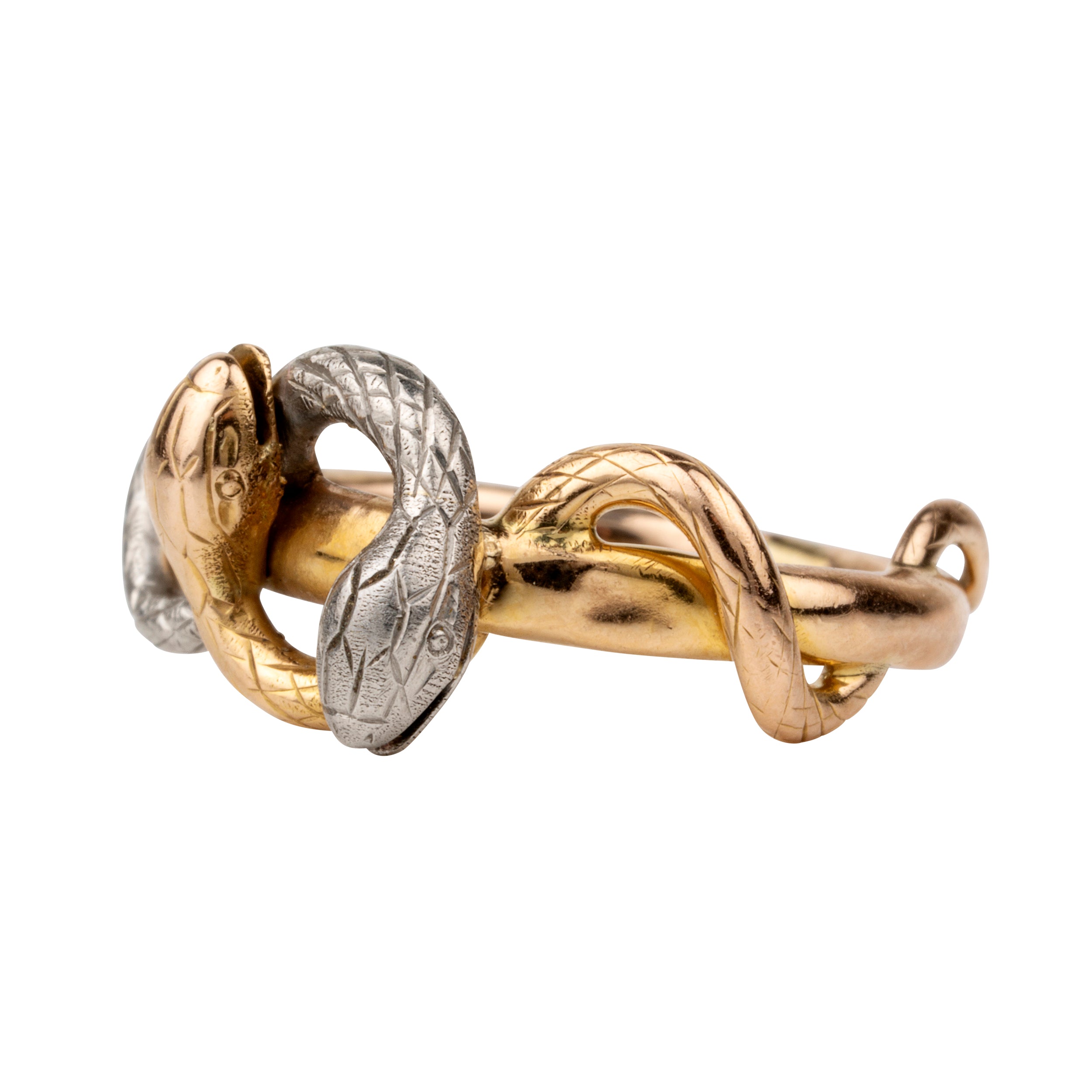 Turn of the century entwined snake ring, in platinum and gold. Hollow construction. There is a small dent on the band next to the platinum snake head. England. Circa 1910.