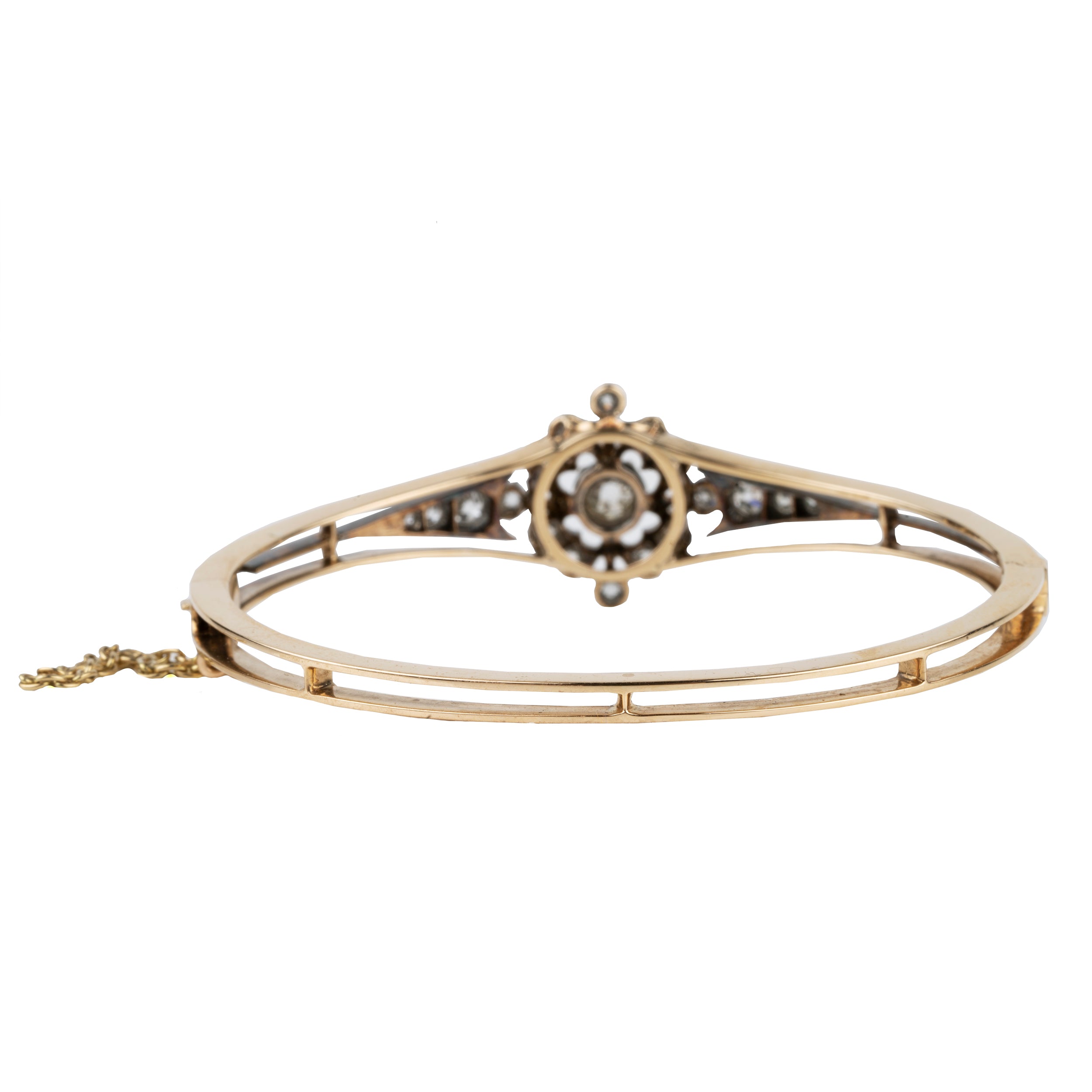 Late 19th century floral diamond bangle bracelet, in silver topped gold. The center diamond is an old mine cut diamond, approximately .75 carats, flanked by additional old mine cut diamonds. English in origin. Circa 1890. Back view.