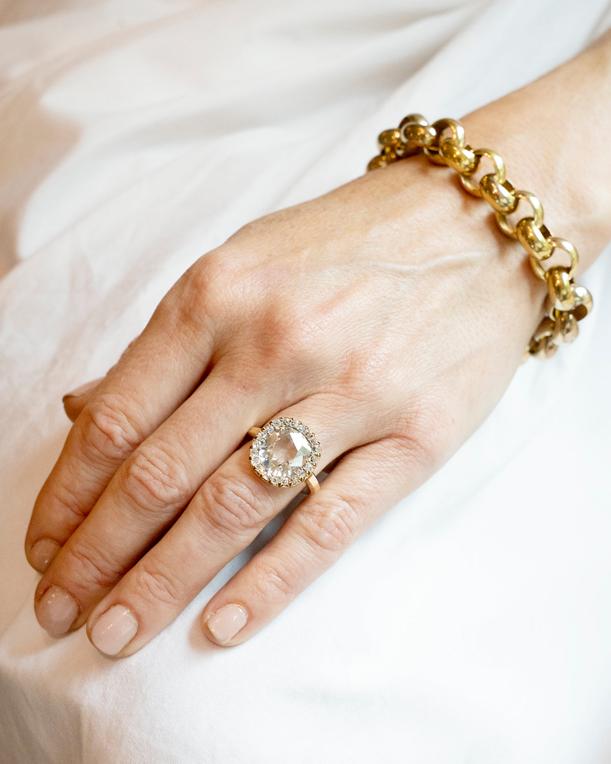 Bell and Bird Diamond Cluster Ring with a gold bracelet