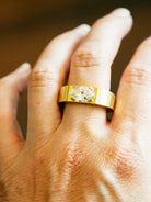 Oversize solitaire setting inspired by the ancient Roman high carat gold stir-up shaped rings we have handled. The tab prongs setting allows for a minimal yet bold setting. This ring features a moval cut diamond of 2.05 carats, F color and VS1 clarity. Made in our custom 18k yellow gold with a subtle soft finished polish.