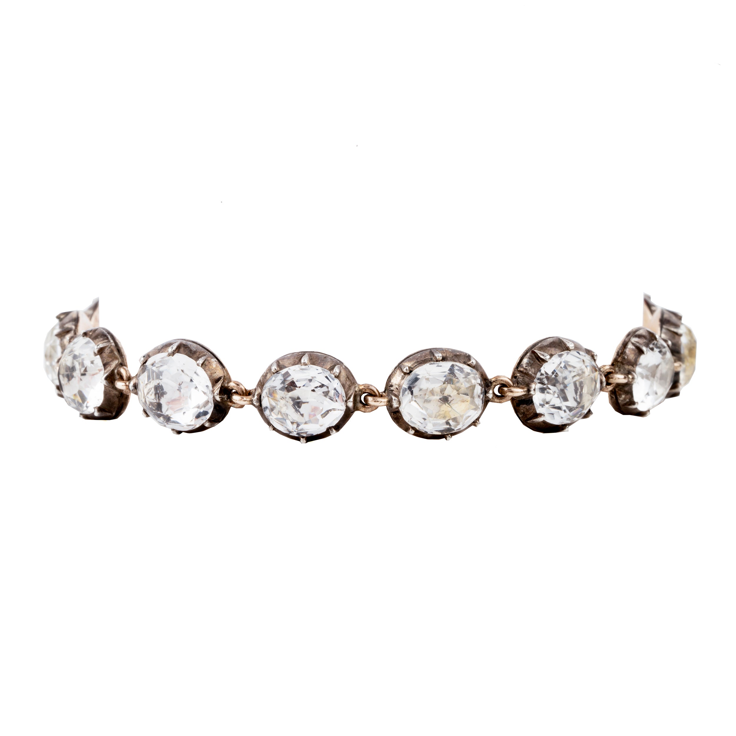 In the same form as the highly desired paste rivière necklaces, this bracelet was likely once part of a larger parure. The stones are not leaded glass paste but rock crystal quartz. Each is slightly different in size and proportion. Set in silver-topped gold collet settings. England, circa 1820. Front view.