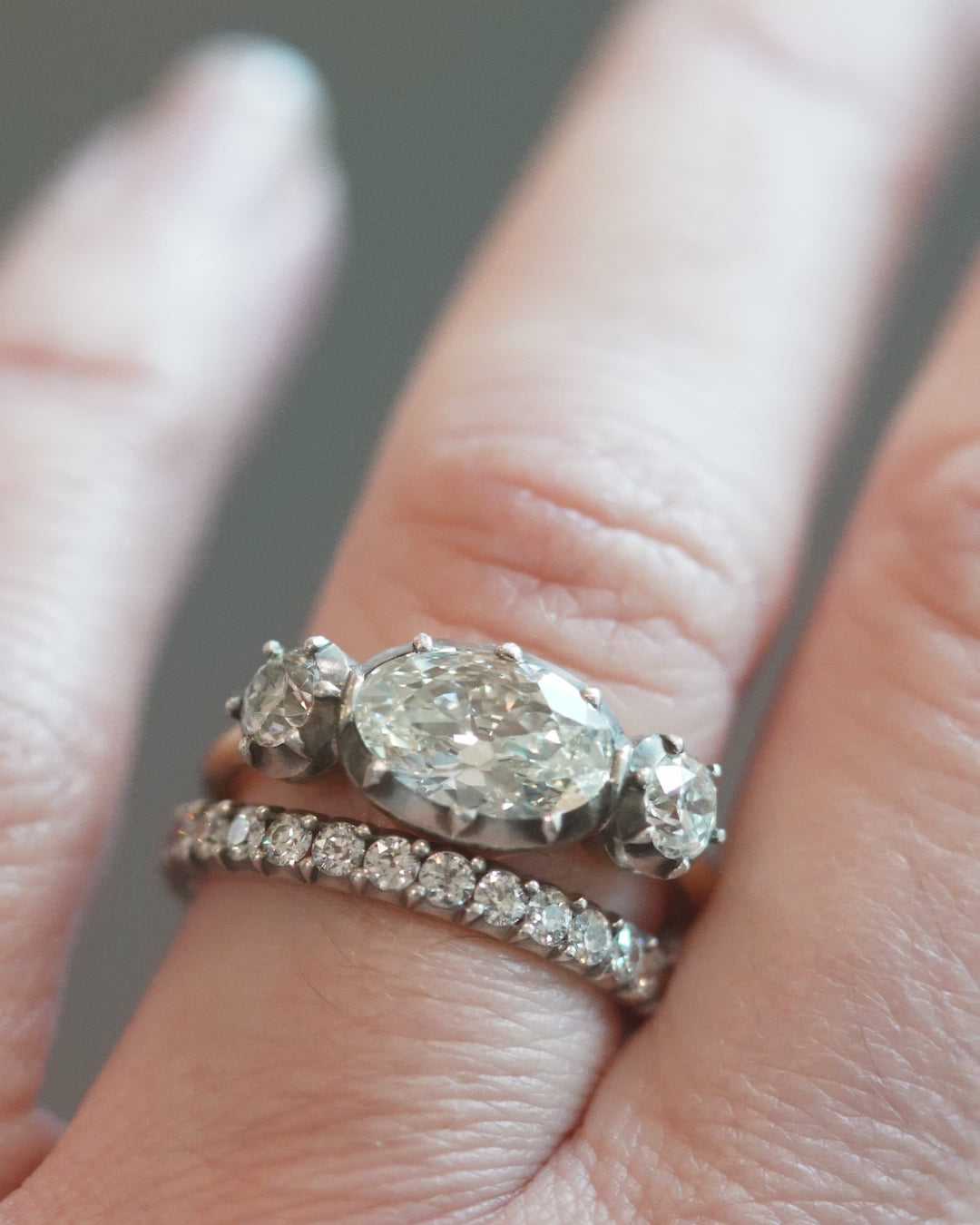 One of our signature designs, in silver-topped 18k gold. This design is inspired by a labor-intensive setting technique common in 18th and 19th-century rings. The silver-on-gold technique is true to the rings that inspired this design and is rarely seen in modern jewelry. This ring features a GIA certified cushion cut diamond, 1.58 carat, I color and VS2 clarity.The center stone is paired with approximately .30 carat and .28 carat I color and VS2 clarity old mine cut diamonds.Video of the ring being modeled