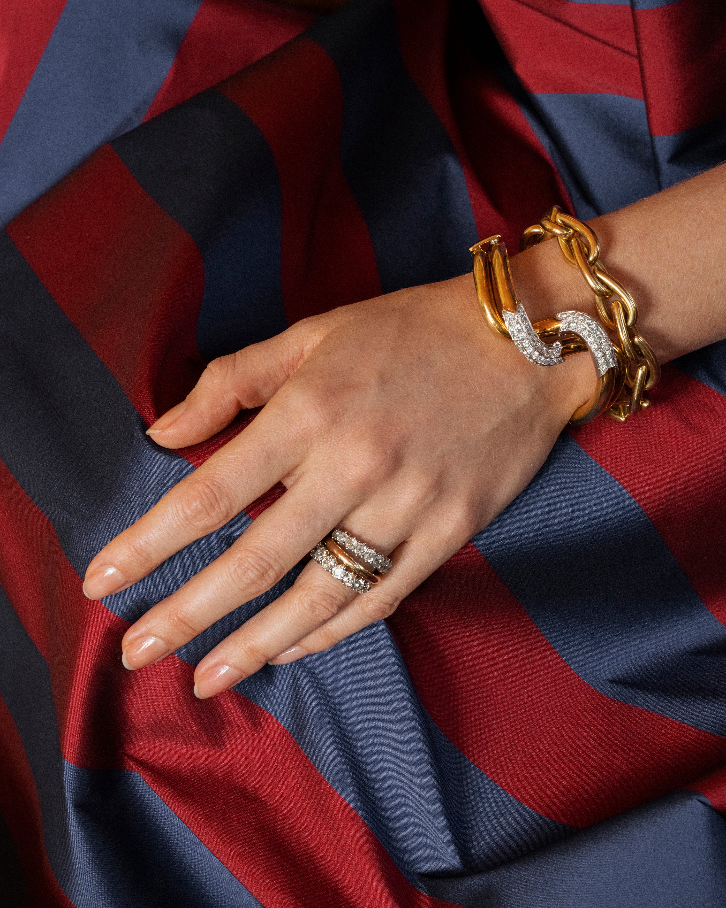 One of our signature designs. Each ring features a unique collection of slightly graduated antique diamonds. Collecting a suite of stones in matched size, color, and clarity often takes months. This ring features sixteen turn-of-the-century, old European cut diamonds, approximately 4.41 carats in total diamond weight The diamond grades range from approximately H-J color and VS-SI clarity. Being modeled on a hand.