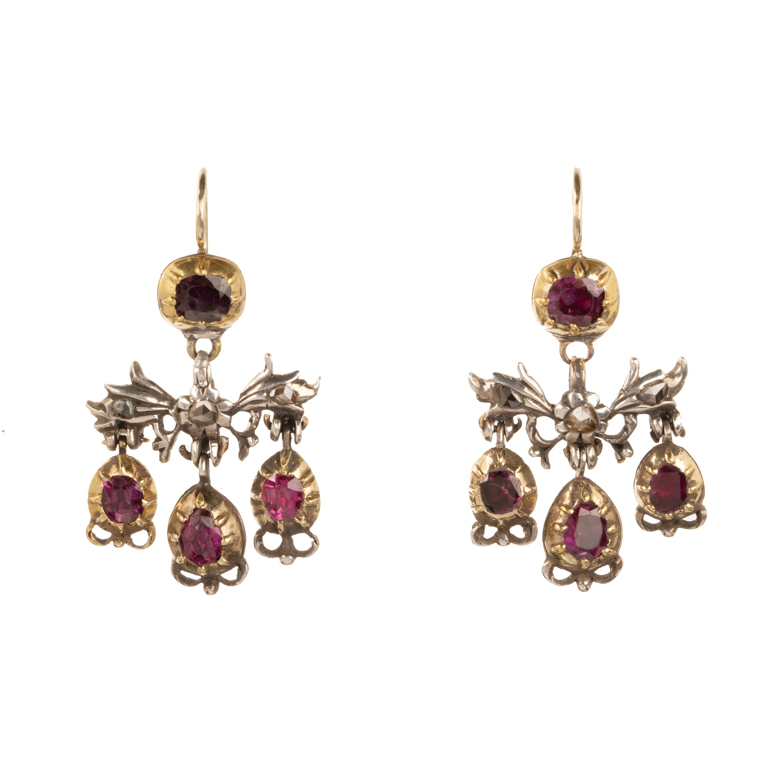 The girandole design consists of three pear-shaped drops suspended from a central bow motif. The design was popular towards the end of the 17th century through the 18th century. When the style's popularity diminished, elements were often disassembled and utilized in reduced form, making examples in original form quite rare. Rose-cut diamonds are set into the central element in silver, while the ruby stones are set in 18k gold. Continental Europe, circa 1760. Front view.
