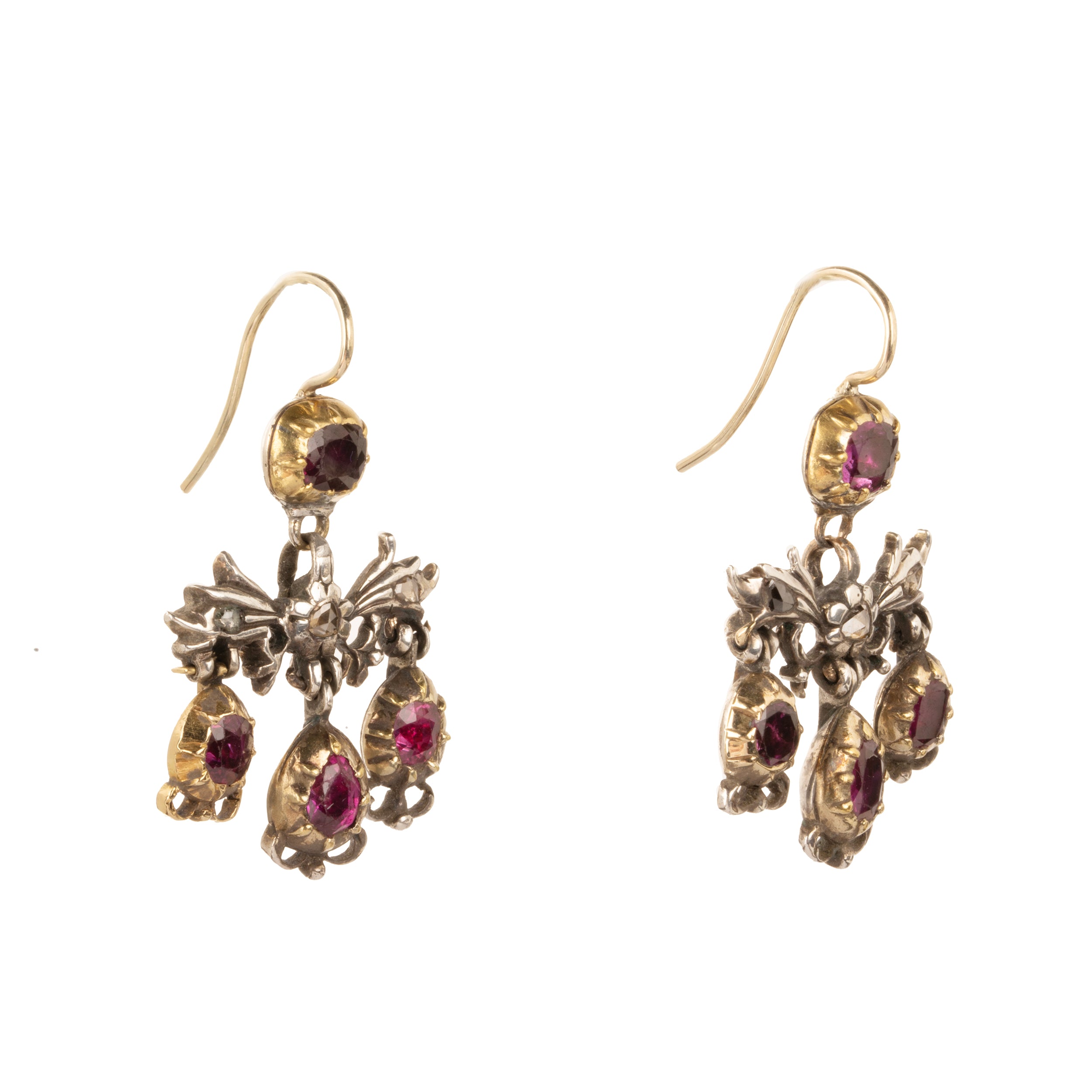 The girandole design consists of three pear-shaped drops suspended from a central bow motif. The design was popular towards the end of the 17th century through the 18th century. When the style's popularity diminished, elements were often disassembled and utilized in reduced form, making examples in original form quite rare. Rose-cut diamonds are set into the central element in silver, while the ruby stones are set in 18k gold. Continental Europe, circa 1760. Side view.