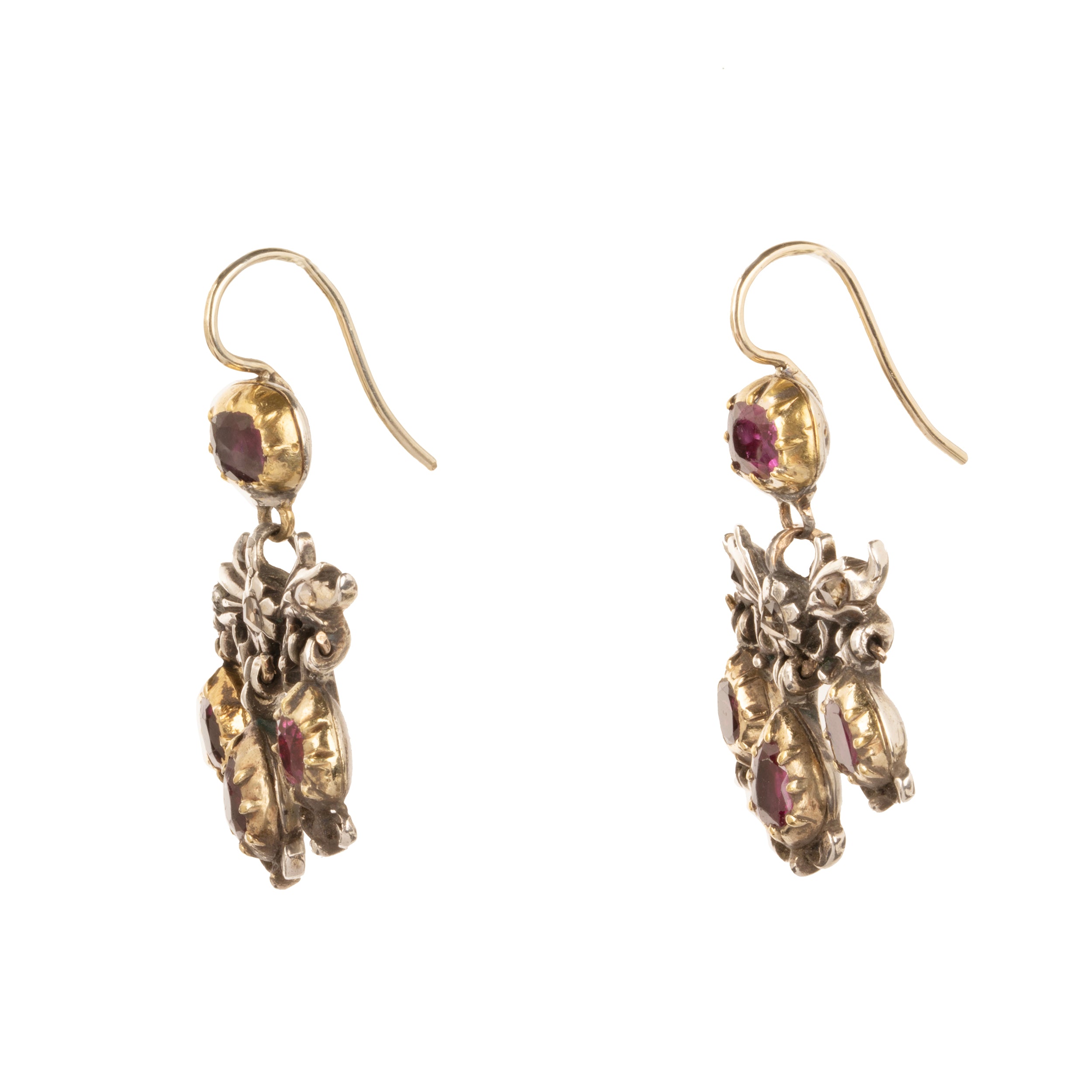 The girandole design consists of three pear-shaped drops suspended from a central bow motif. The design was popular towards the end of the 17th century through the 18th century. When the style's popularity diminished, elements were often disassembled and utilized in reduced form, making examples in original form quite rare. Rose-cut diamonds are set into the central element in silver, while the ruby stones are set in 18k gold. Continental Europe, circa 1760. Side view.
