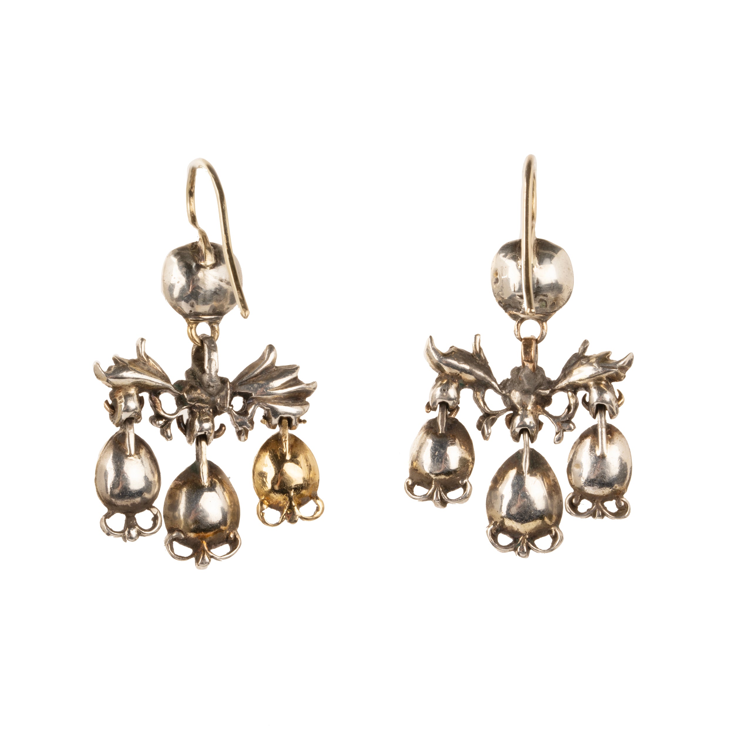 The girandole design consists of three pear-shaped drops suspended from a central bow motif. The design was popular towards the end of the 17th century through the 18th century. When the style's popularity diminished, elements were often disassembled and utilized in reduced form, making examples in original form quite rare. Rose-cut diamonds are set into the central element in silver, while the ruby stones are set in 18k gold. Continental Europe, circa 1760. Back side view.