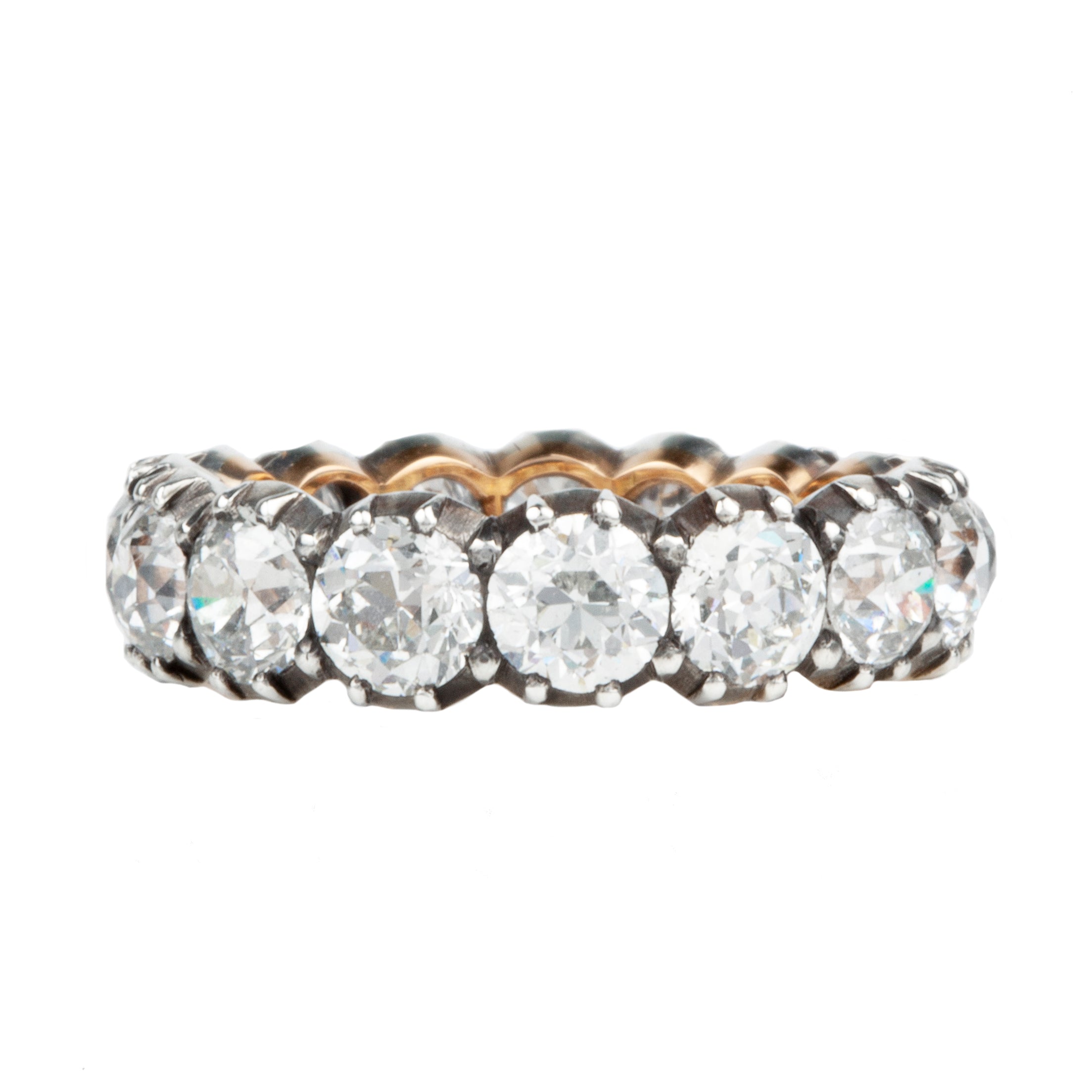 One of our signature designs. Each ring features a unique collection of slightly graduated antique diamonds. Collecting a suite of stones in matched size, color, and clarity often takes months. This ring features sixteen turn-of-the-century, old European cut diamonds, approximately 4.41 carats in total diamond weight The diamond grades range from approximately H-J color and VS-SI clarity. Side view.