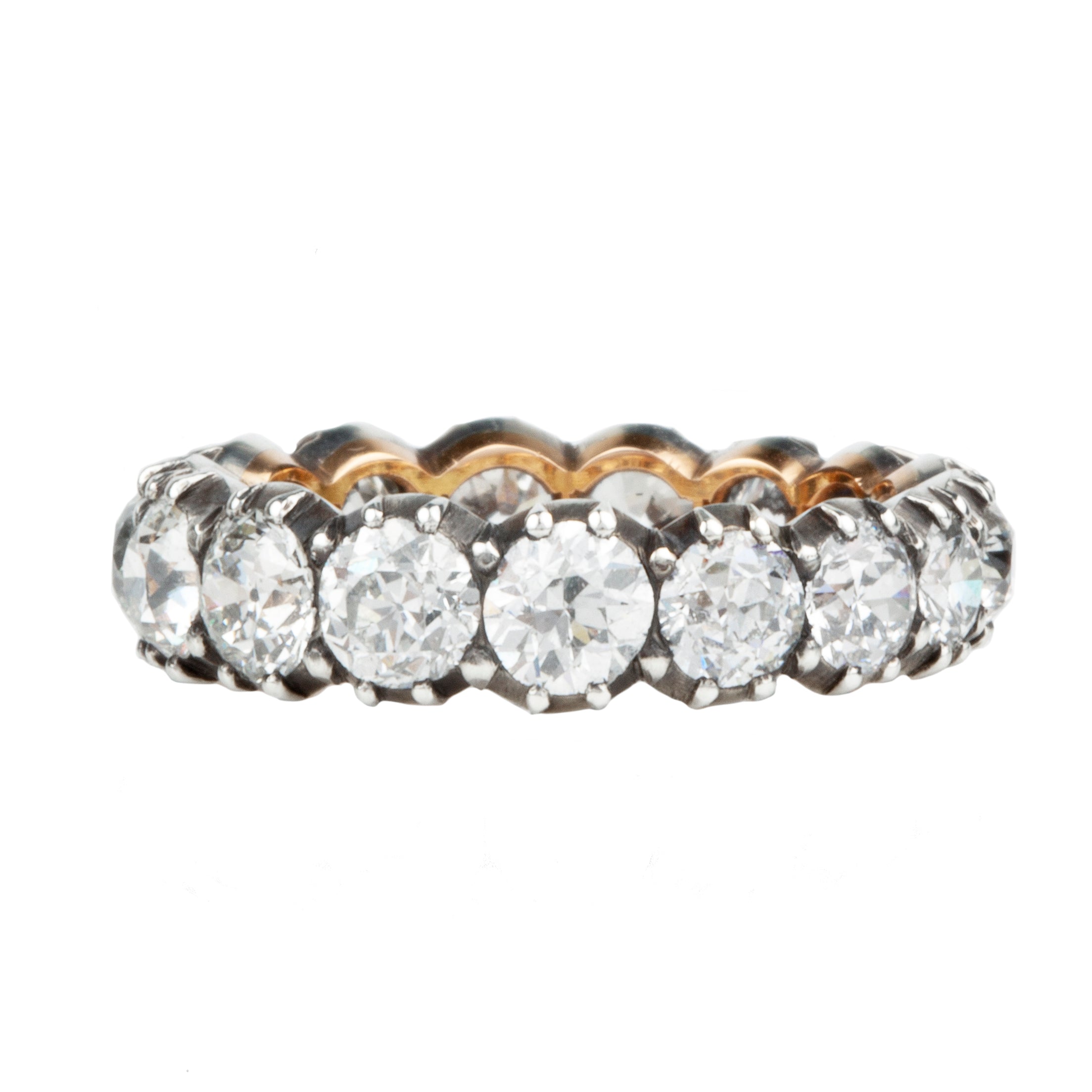 One of our signature designs. Each ring features a unique collection of slightly graduated antique diamonds. Collecting a suite of stones in matched size, color, and clarity often takes months. This ring features sixteen turn-of-the-century, old European cut diamonds, approximately 4.41 carats in total diamond weight The diamond grades range from approximately H-J color and VS-SI clarity. Front view.