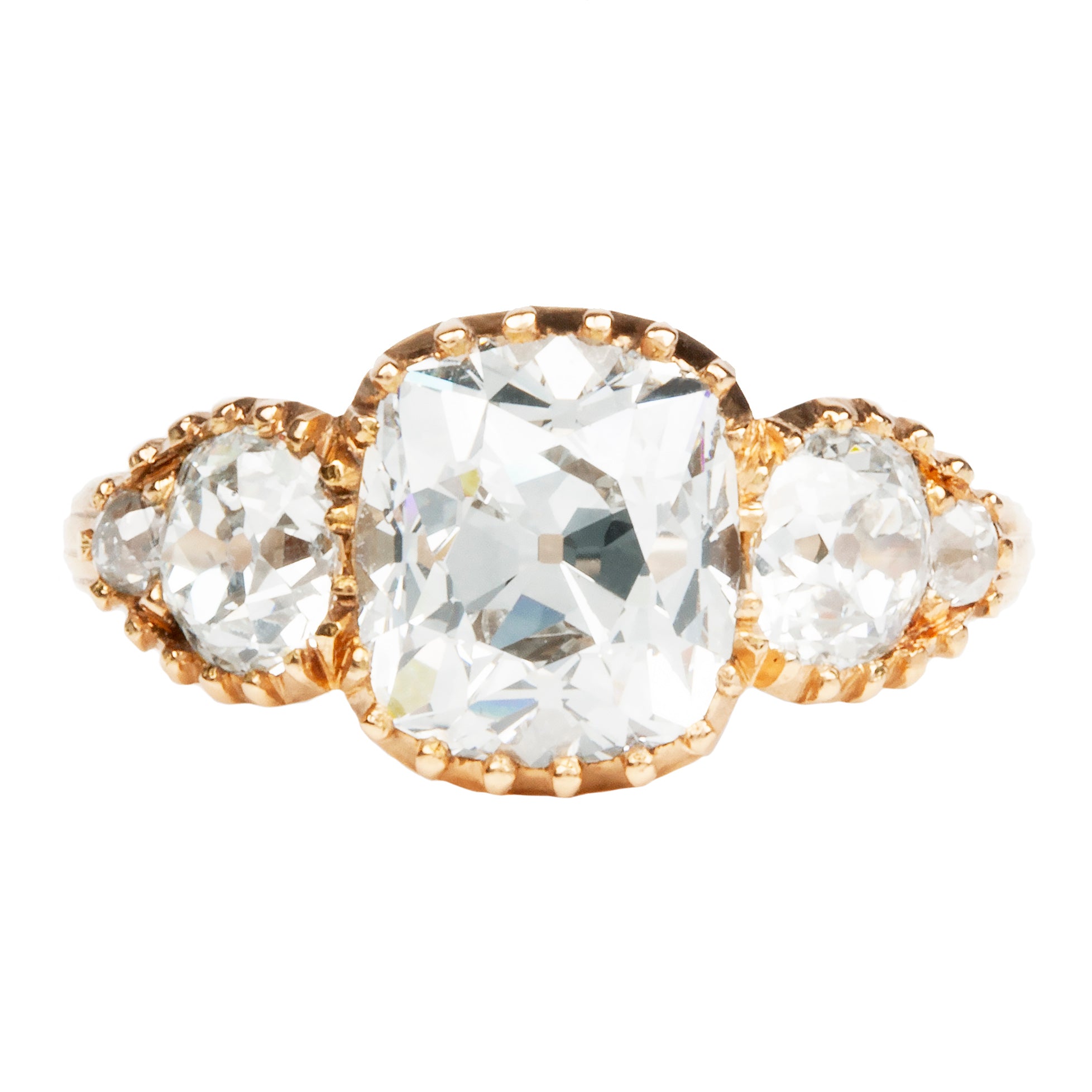 An old mine cut diamond ring with a central diamond surrounded by smaller cut diamonds, set in a ring with a gold band.