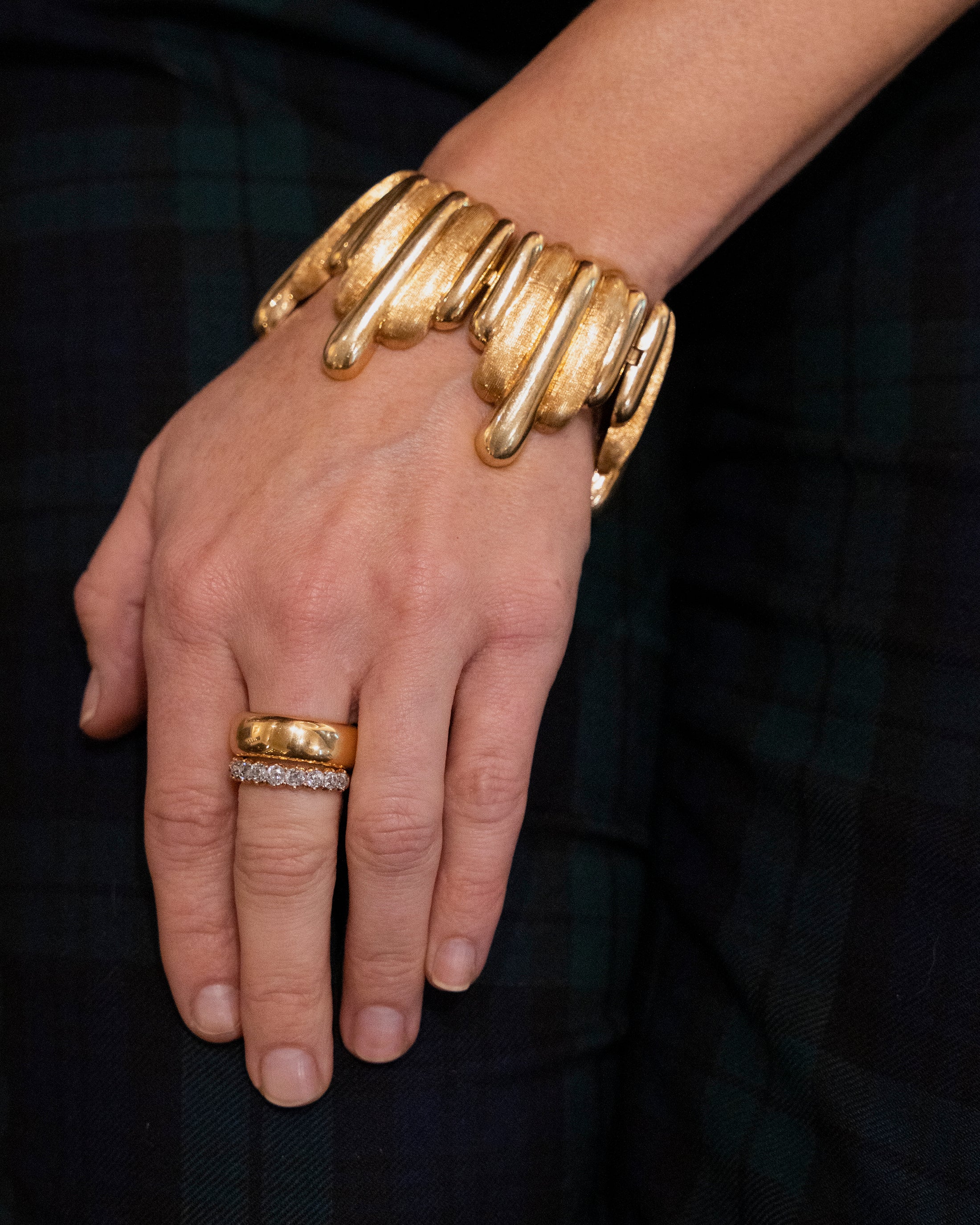 Vintage Gold Surrealist Bracelet. Striking 18k gold bracelet with a dripping motif. Signed by an Italian Maker. Mid 20th century. Model wearing the bracelet along with a heavy gold band and diamond ring.