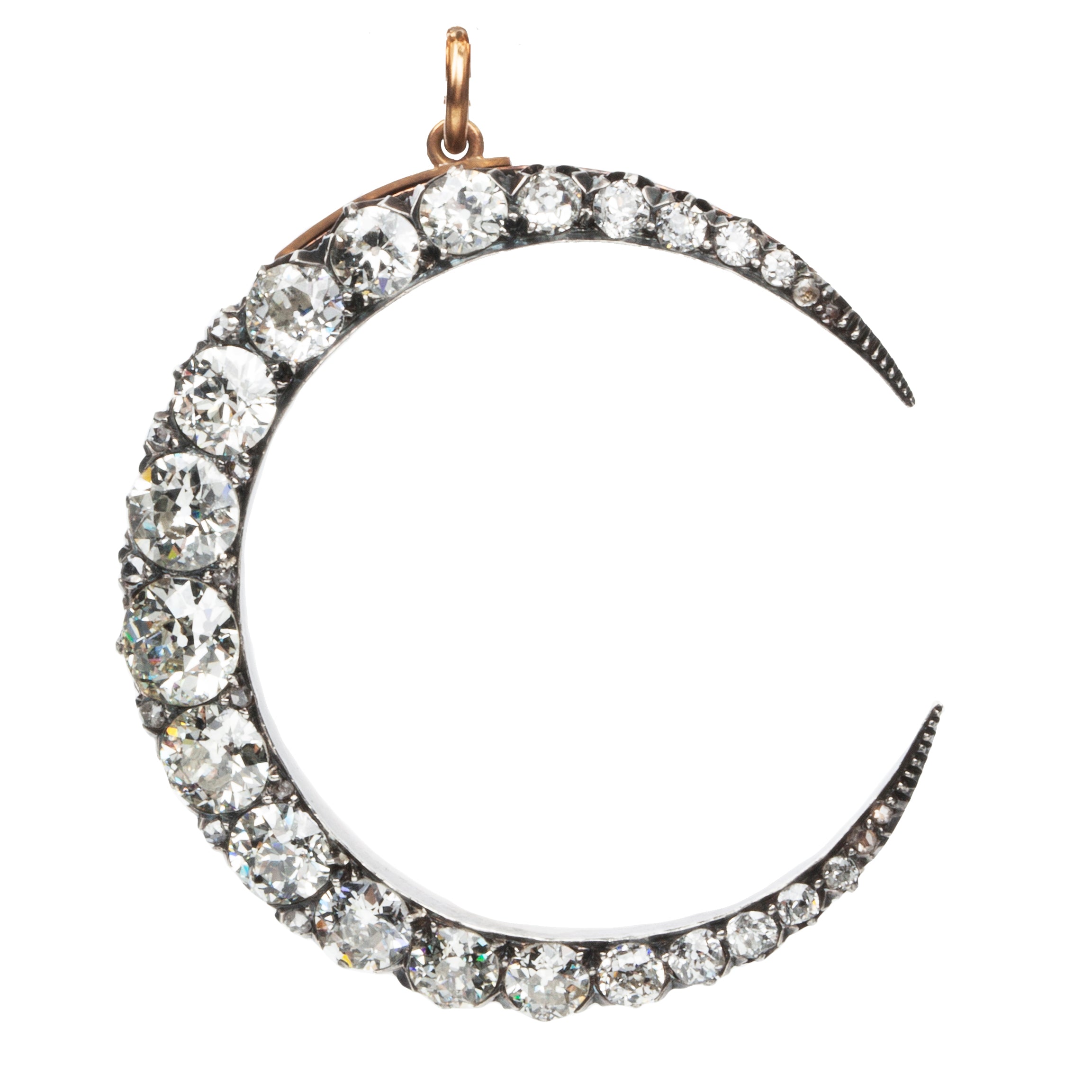 A slender arc of light executed in glittering old mine cut diamonds. Crafted in a silver-topped gold setting this piece has been masterfully constructed to function as a brooch and a pendant with the original fixtures still intact. Approximately 7.20 carats in total diamond weight. English in origin. Front view.