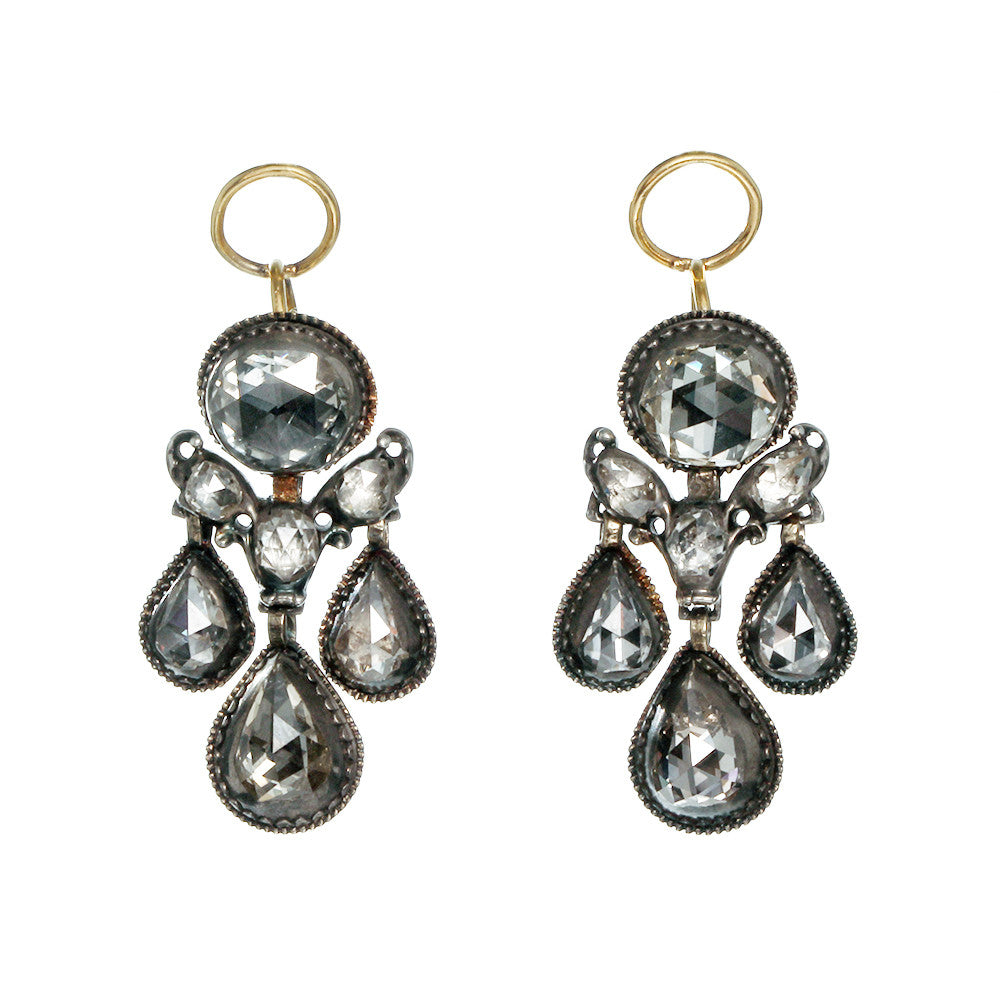 A pair of Dutch rose cut diamond earrings with silver and gold colors, featuring high domed rose cut diamonds and a gold hoop.