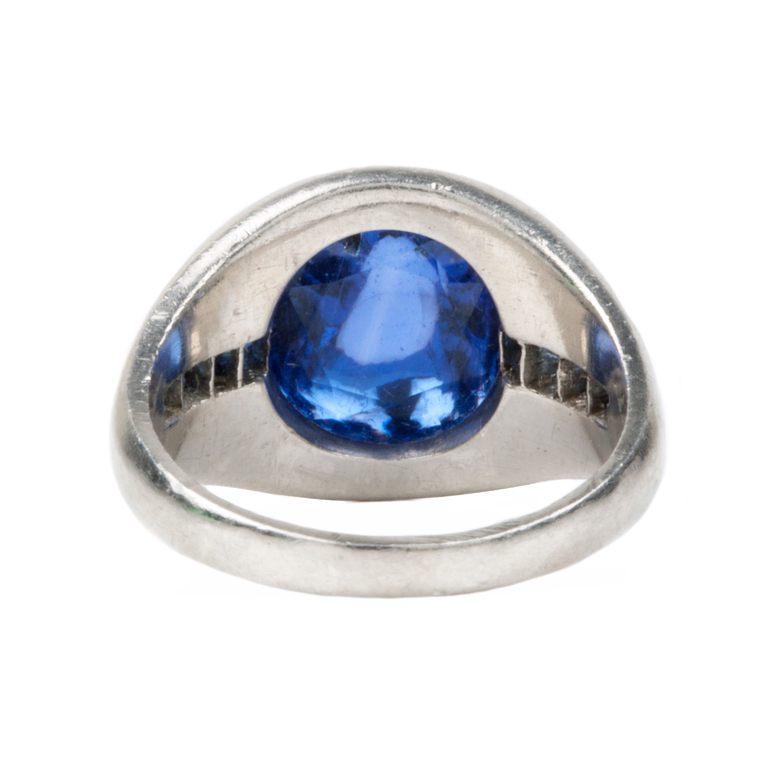 Early 20th-century platinum ring with unique high-domed Sugarloaf cabochon sapphire in a heavy platinum setting. Approximately 5 carat no-heat Ceylon Sapphire with AGL certificate indicating origin and no treatment of any kind. Beautiful cornflower blue with matched step-cut side stones. The center stone has fantastic clarity.Circa 1920.