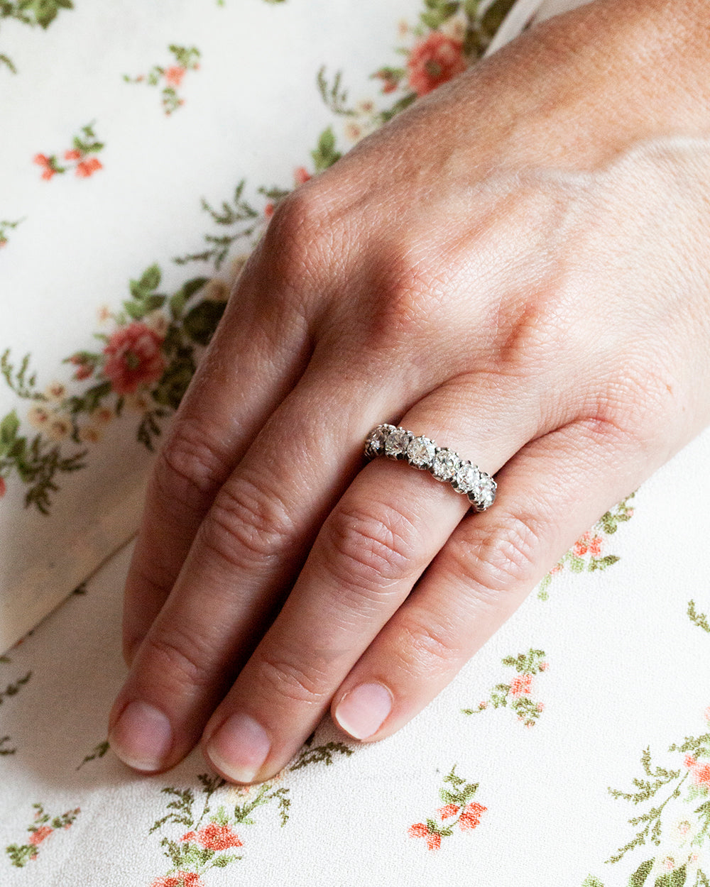 One of our signature designs. Each ring features a unique collection of slightly graduated antique diamonds. Collecting a suite of stones in matched size, color, and clarity often takes months. This ring features sixteen turn-of-the-century, old European cut diamonds, approximately 4.41 carats in total diamond weight The diamond grades range from approximately H-J color and VS-SI clarity. Being modeled on hand.