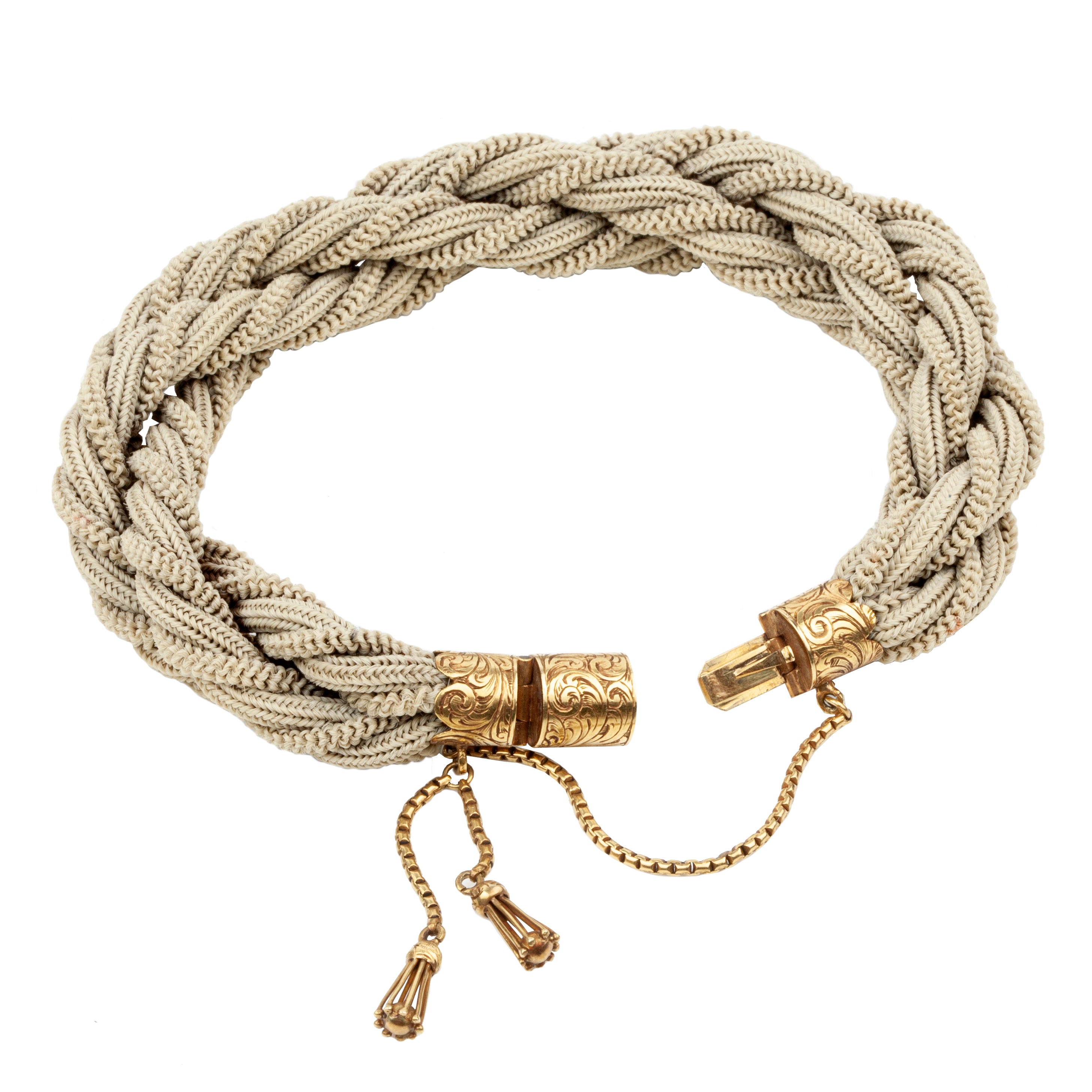 Victorian Era woven hair bracelet, with gold clasp and tassel details. Remarkably preserved twisted woven braids. English in origin. Circa 1860.