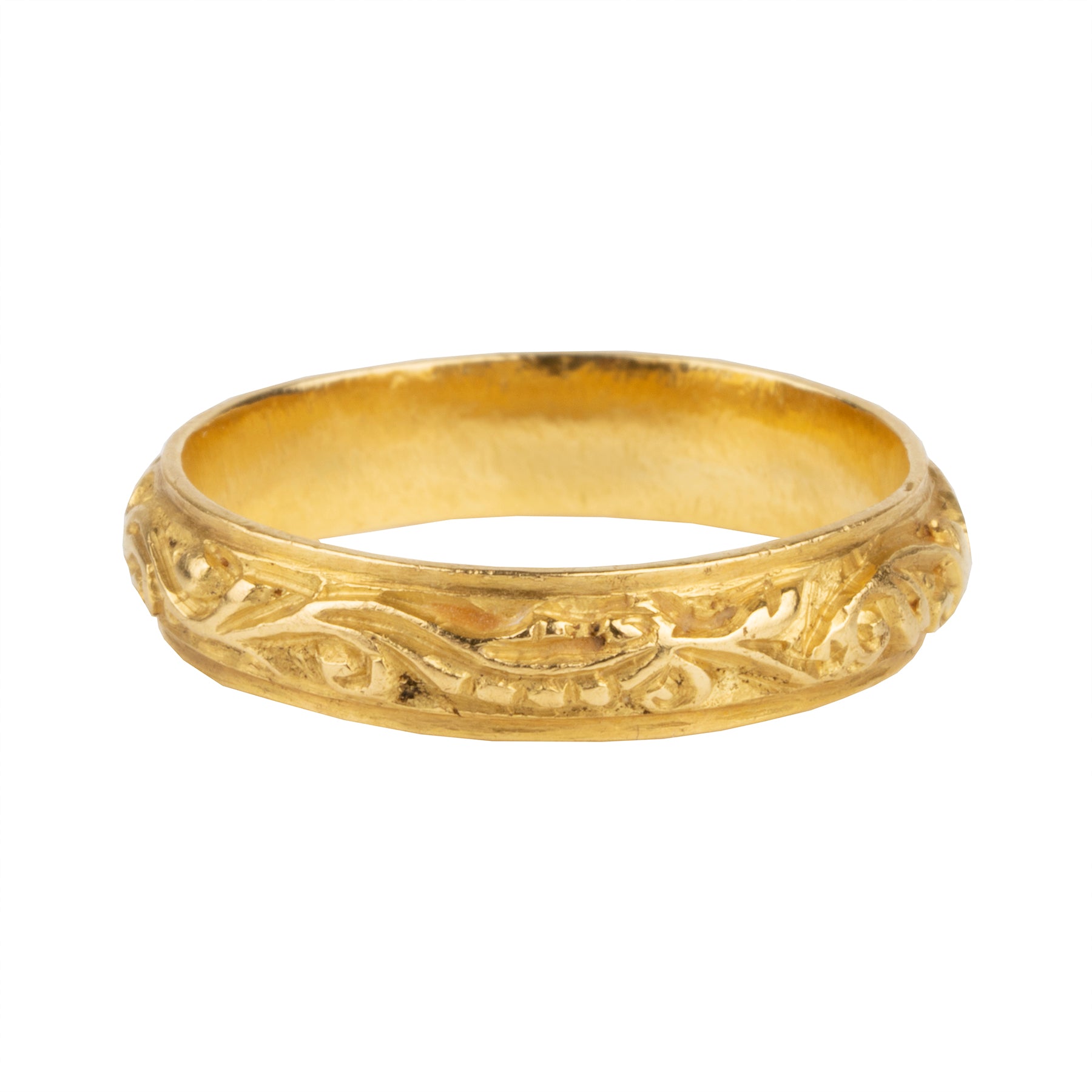 A rare excavated ring. Dating to the late 17th Century in 22k gold, 5mm wide. There would have originally been enamel within the deeply chased design. Excavated in England. Circa 1680.