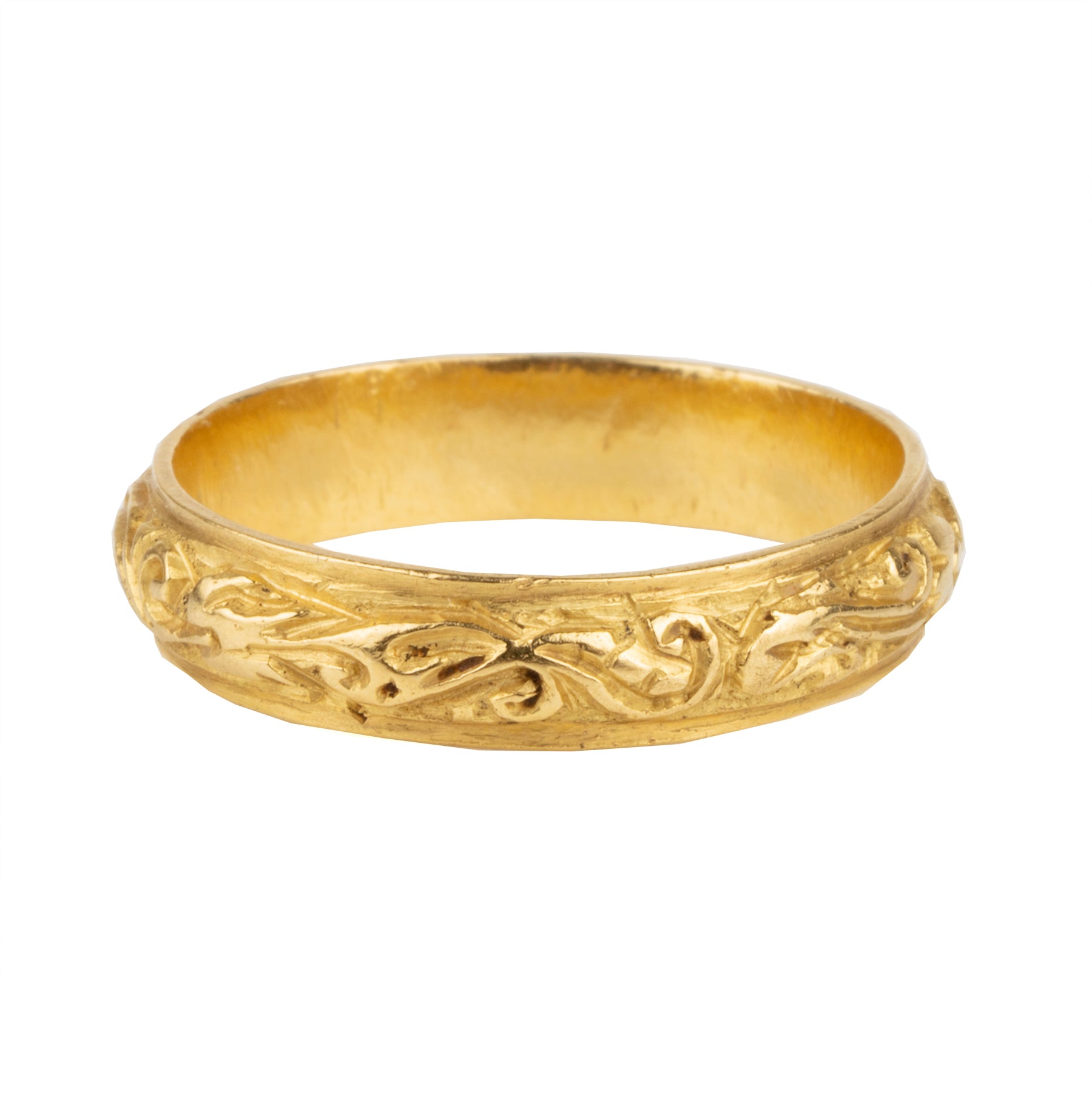 A rare excavated ring. Dating to the late 17th Century in 22k gold, 5mm wide. There would have originally been enamel within the deeply chased design. Excavated in England. Circa 1680.