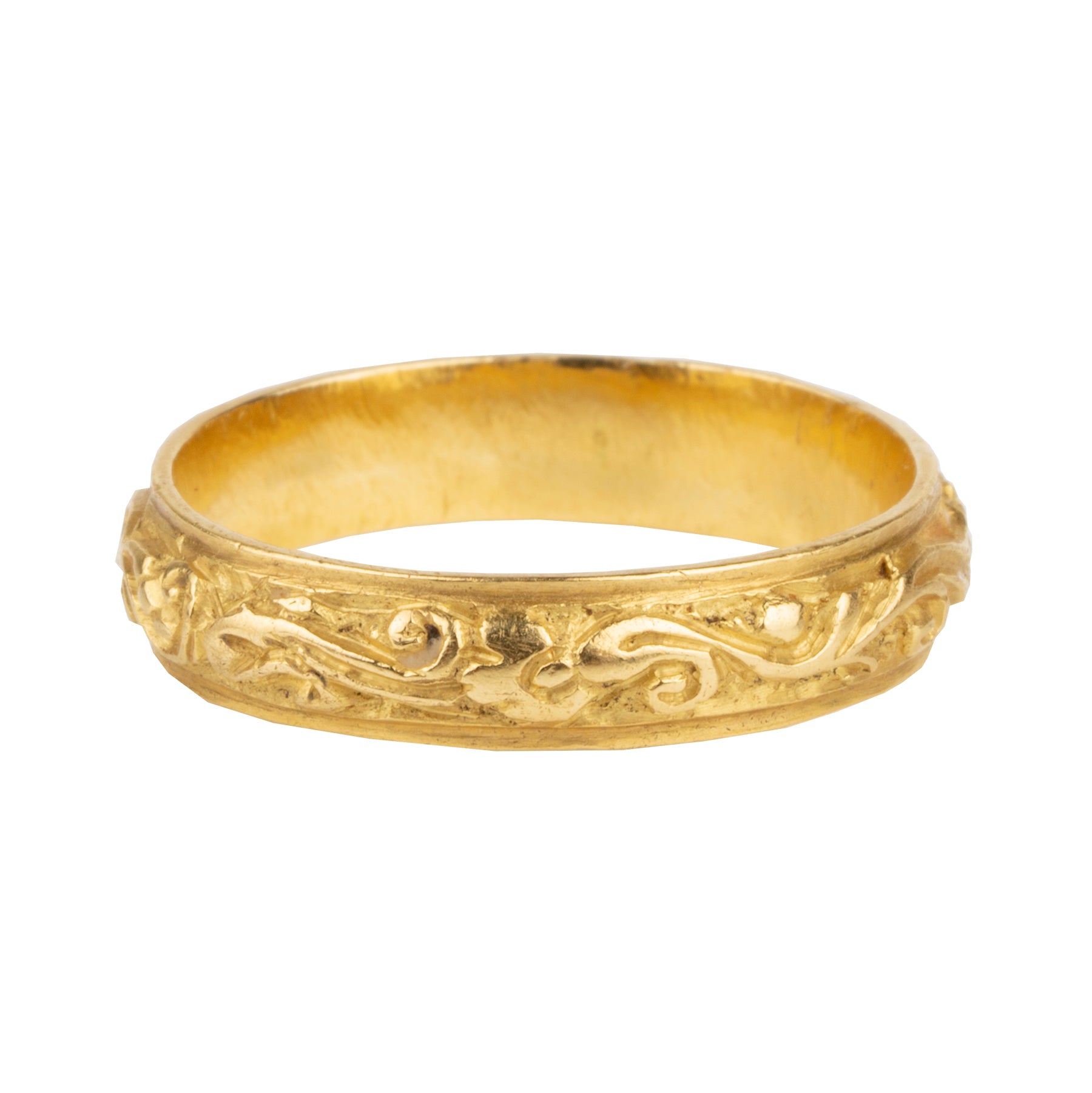 A rare excavated ring. Dating to the late 17th Century in 22k gold, 5mm wide. There would have originally been enamel within the deeply chased design. Excavated in England. Circa 1680.