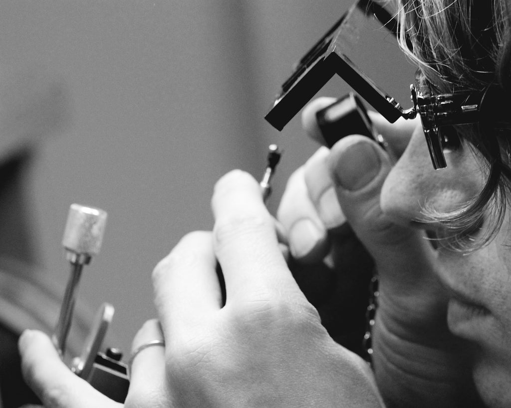Jeweler looking at a gemstone with a loop