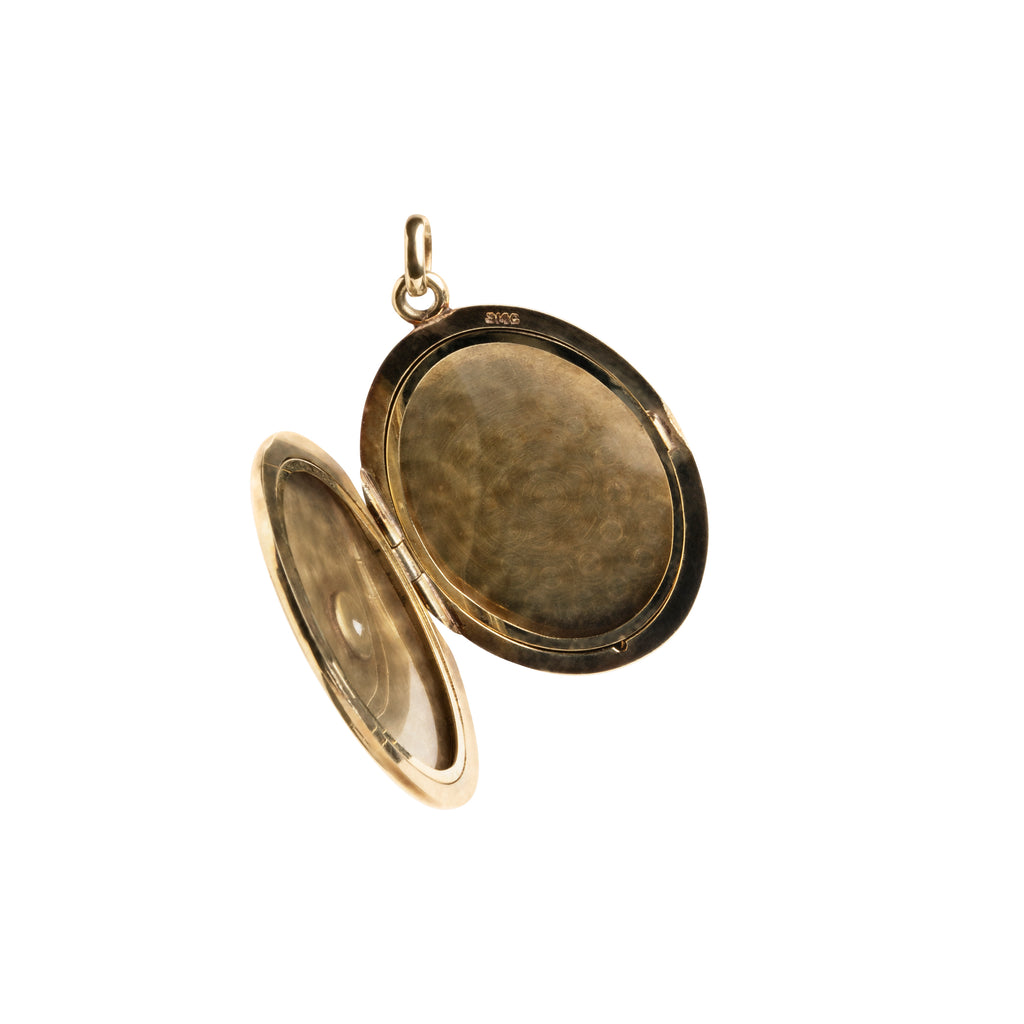 Turn of the century era black enamel and old mine cut diamond locket, in 15k gold. The original frame is still intact. Personal images can be placed in the locket.English in Origin. Circa 1900.