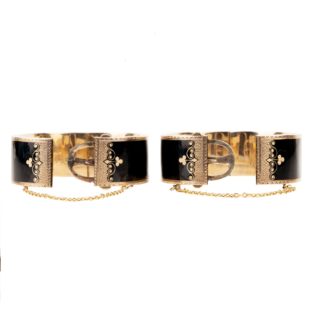 In the 19th century, the Lilly of the Valley flower was a common mourning motif that symbolized a return to happiness. This is a nicely preserved set of 14k gold bracelets with black enamel, pearls and delicate engraving. They are small in size, measuring 5.25 inches in circumference. American, circa 1870. Side view with claps opened. 