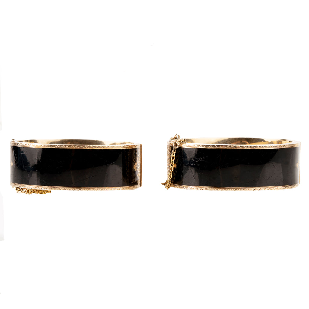 In the 19th century, the Lilly of the Valley flower was a common mourning motif that symbolized a return to happiness. This is a nicely preserved set of 14k gold bracelets with black enamel, pearls and delicate engraving. They are small in size, measuring 5.25 inches in circumference. American, circa 1870. Back view. 