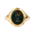 Victorian era deer intaglio signet ring, in 18k gold. Carved bloobstone intaglio depicted a deer holding a brand of leaves set in an engraved gold ring. England. Circa 1870.