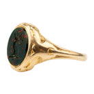 Victorian era deer intaglio signet ring, in 18k gold. Carved bloobstone intaglio depicted a deer holding a brand of leaves set in an engraved gold ring. England. Circa 1870.