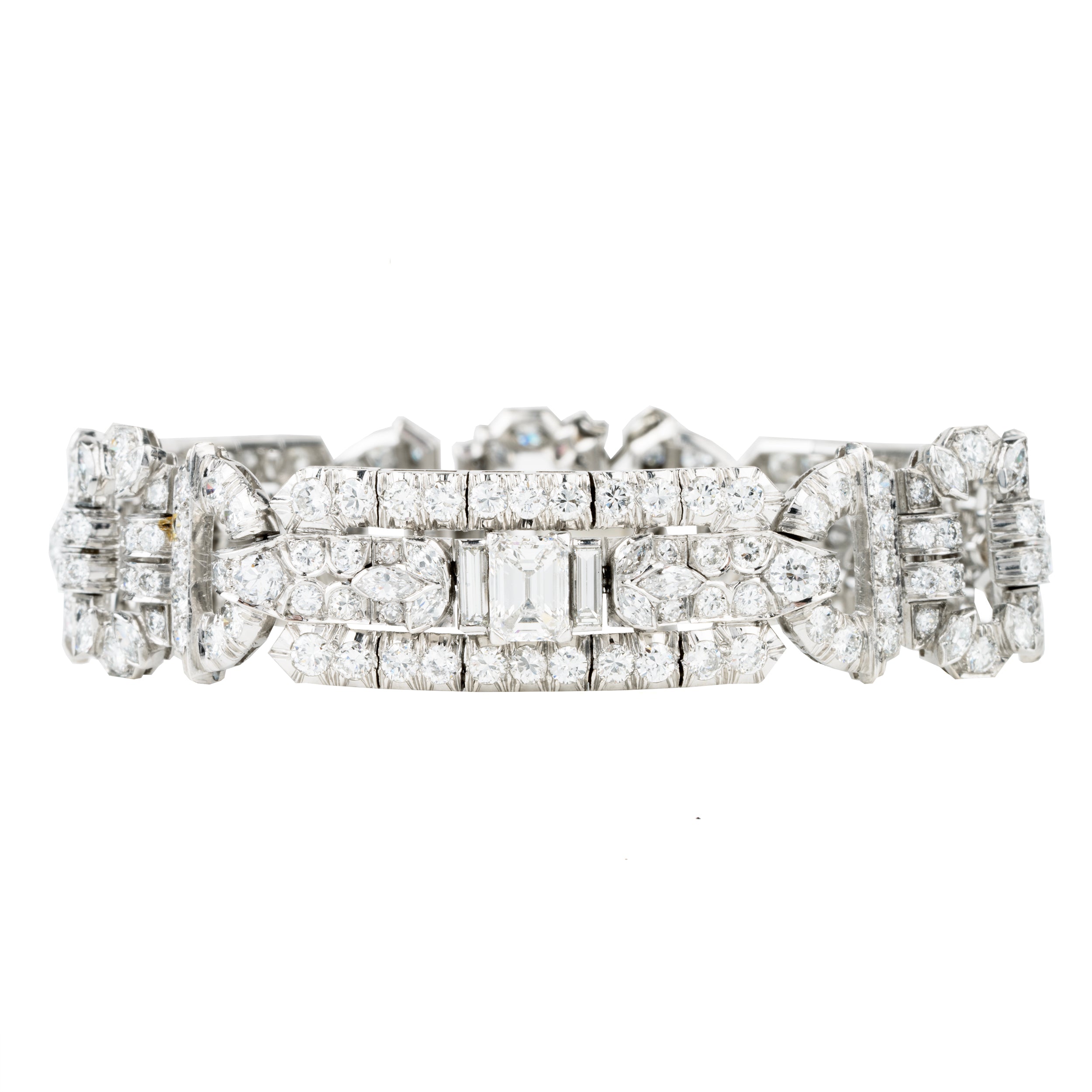 Art Deco platinum and diamond bracelet. Approximately twelve carats of diamonds make up this antique bracelet. There are more than 250 diamonds set in beautifully executed platinum work. The stone shapes include round brilliant cut, single cut, emerald cut, marquise shapes, and baguette shapes. The largest stones are three emerald-cut diamonds weighing approximately .8 carats each. America, circa 1920.