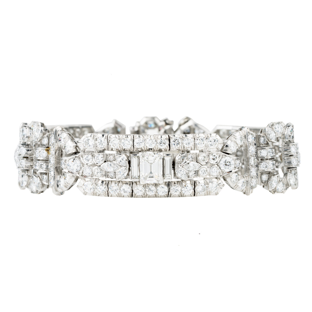 Art Deco platinum and diamond bracelet. Approximately twelve carats of diamonds make up this antique bracelet. There are more than 250 diamonds set in beautifully executed platinum work. The stone shapes include round brilliant cut, single cut, emerald cut, marquise shapes, and baguette shapes. The largest stones are three emerald-cut diamonds weighing approximately .8 carats each. America, circa 1920.