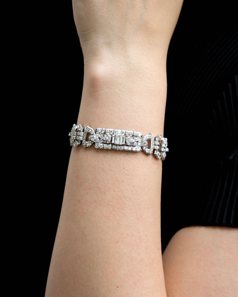 Art Deco platinum and diamond bracelet. Approximately twelve carats of diamonds make up this antique bracelet. There are more than 250 diamonds set in beautifully executed platinum work. The stone shapes include round brilliant cut, single cut, emerald cut, marquise shapes, and baguette shapes. The largest stones are three emerald-cut diamonds weighing approximately .8 carats each. America, circa 1920.