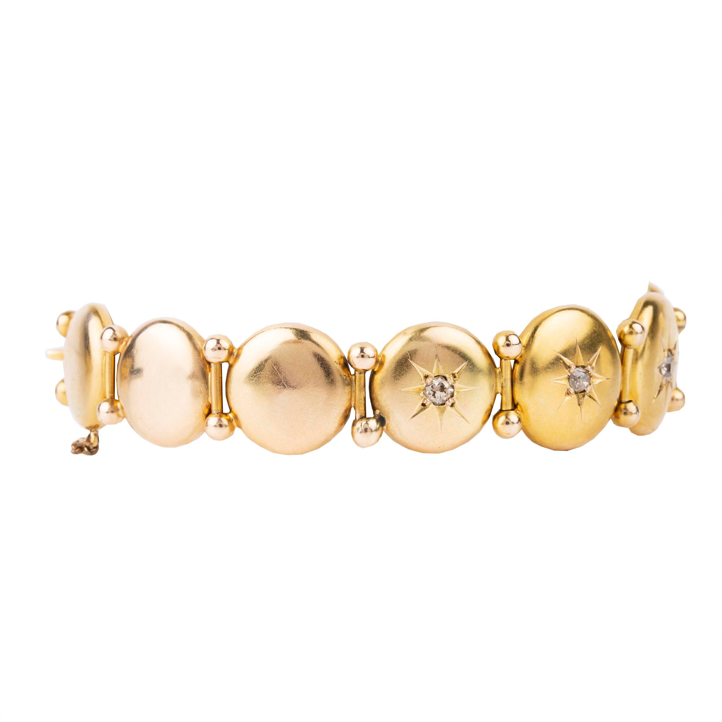 Antique diamond and gold bracelet, in 10k gold. Seven old mine cut diamonds in star detail settings. Approximately .75 carat in total diamond weight. American in origin. Circa 1900.