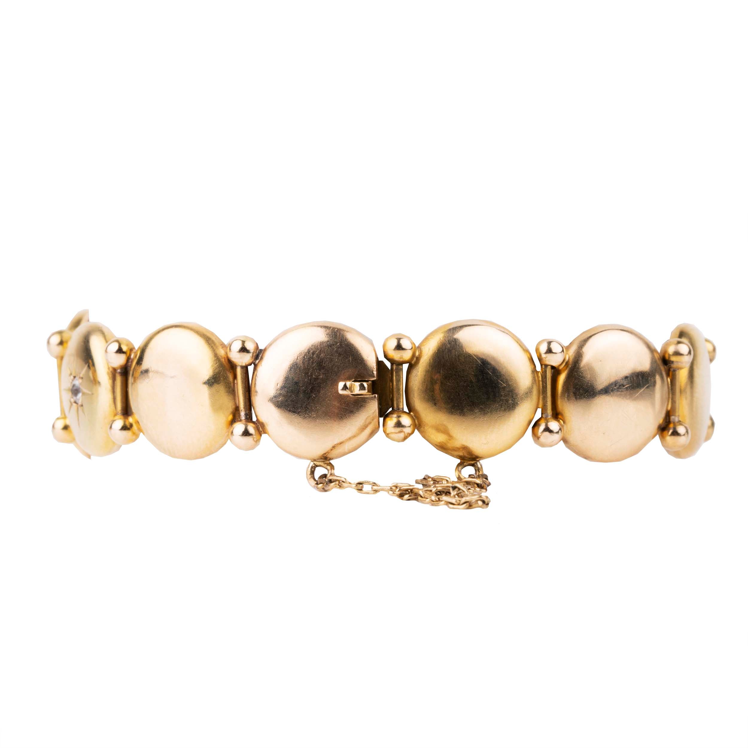 Antique diamond and gold bracelet, in 10k gold. Seven old mine cut diamonds in star detail settings. Approximately .75 carat in total diamond weight. American in origin. Circa 1900.