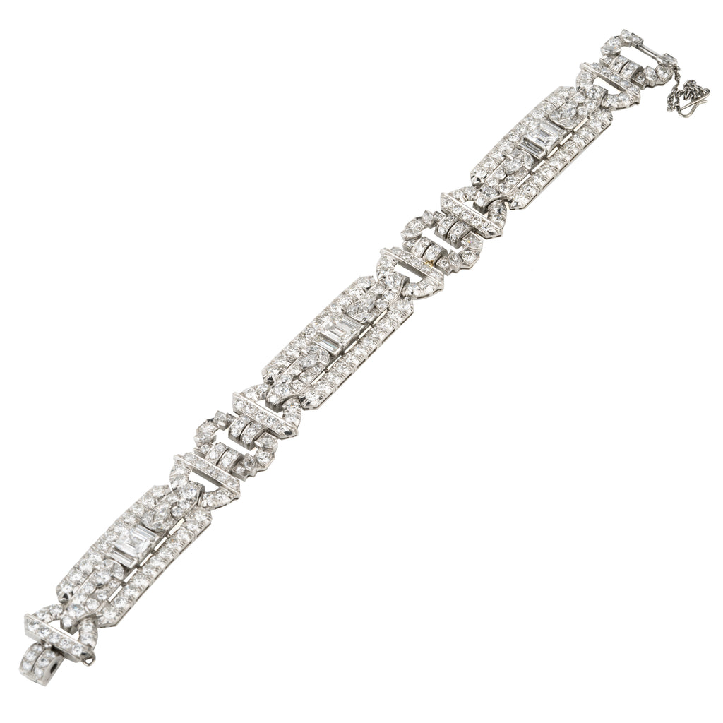 Art Deco platinum and diamond bracelet. Approximately twelve carats of diamonds make up this antique bracelet. There are more than 250 diamonds set in beautifully executed platinum work. The stone shapes include round brilliant cut, single cut, emerald cut, marquise shapes, and baguette shapes. The largest stones are three emerald-cut diamonds weighing approximately .8 carats each. America, circa 1920.