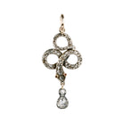 Rose cut diamonds are set&nbsp; in silver topped gold in the form of a snake. The snake is coiled into a trefoil design with a tear drop shaped diamond drop. The detail extends to two tiny ruby eyes. The piece appears to have been converted into a pendant from a brooch or stick pin. England, Circa 1820. Close up front view. 